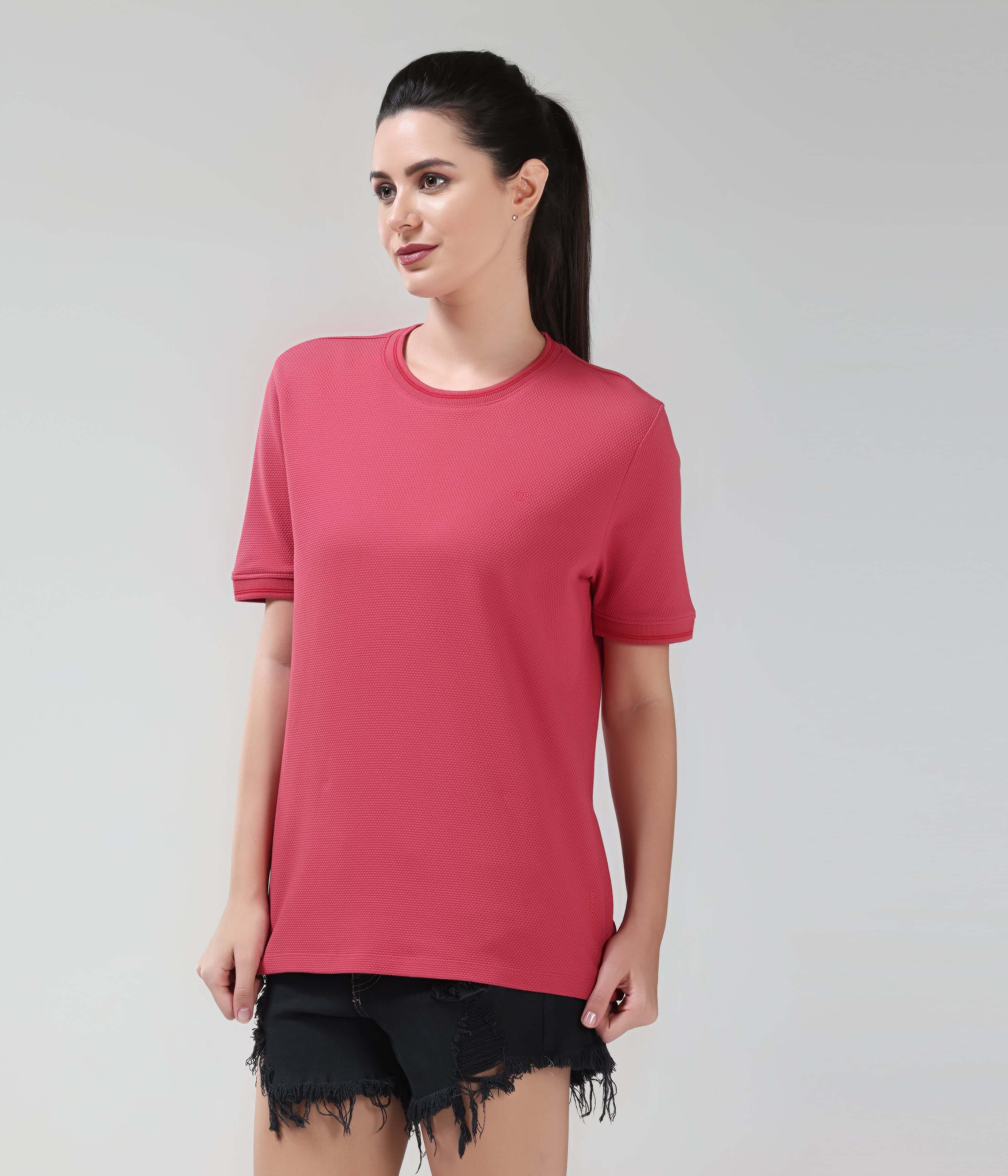 Woman wearing Regal Pink CoolTech T-shirt by Turms, tailored fit, made with anti-odour honeycomb fabric, showcasing new colour in intelligent apparel.