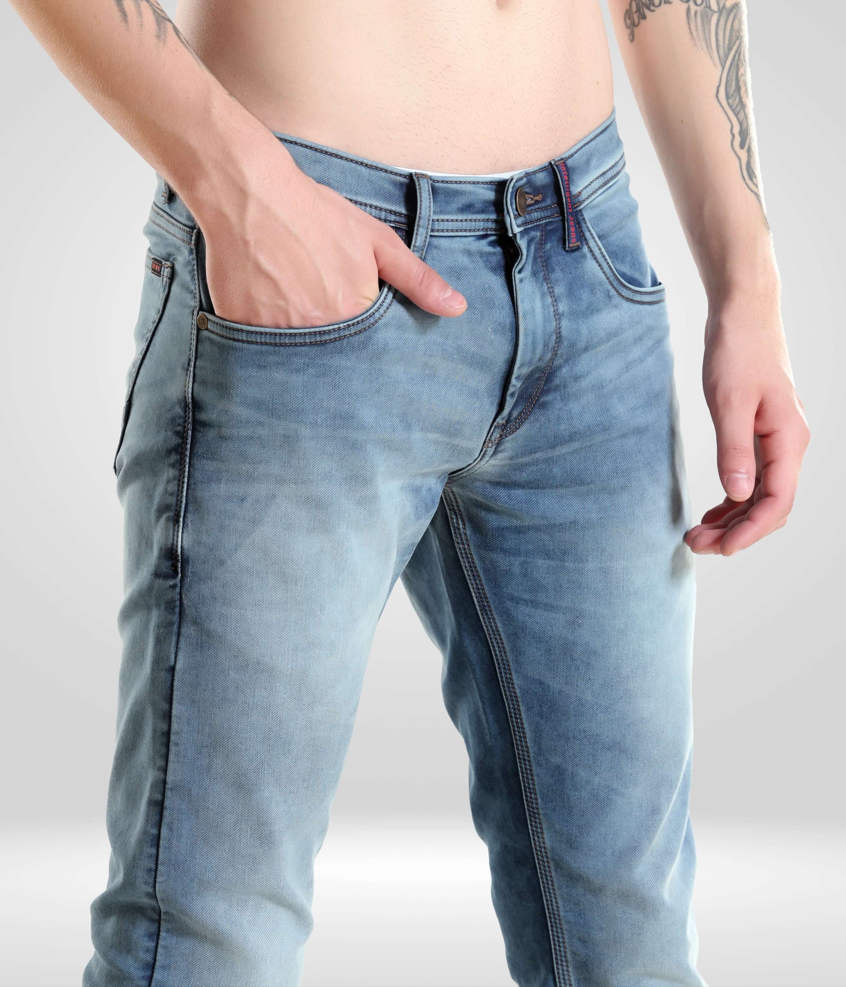 Close-up of a man wearing Blue Birdy high-performance denim pants from Turms Intelligent Apparel, showcasing premium light blue menswear design.