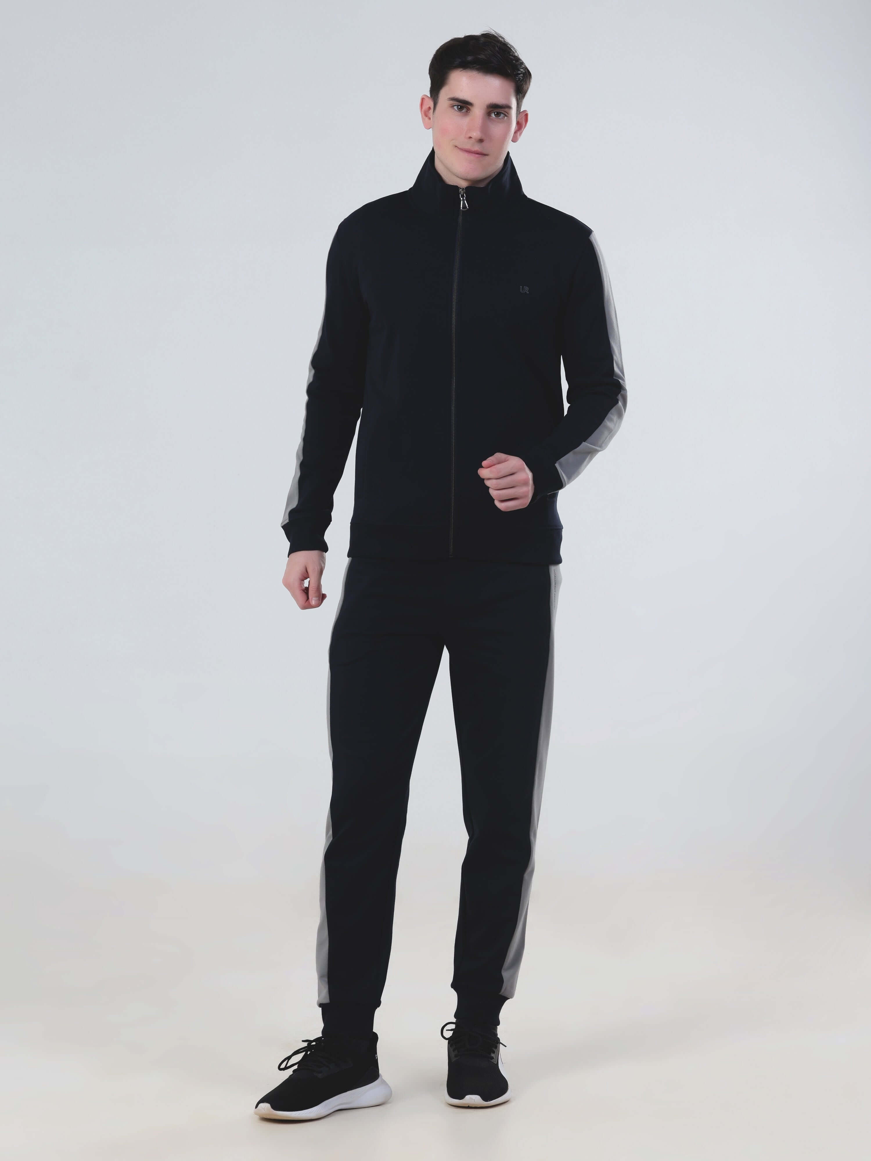 Man wearing Turms Intelligent Cord Set, stylish black co-ord set with a vintage sporty touch and water-resistant features.