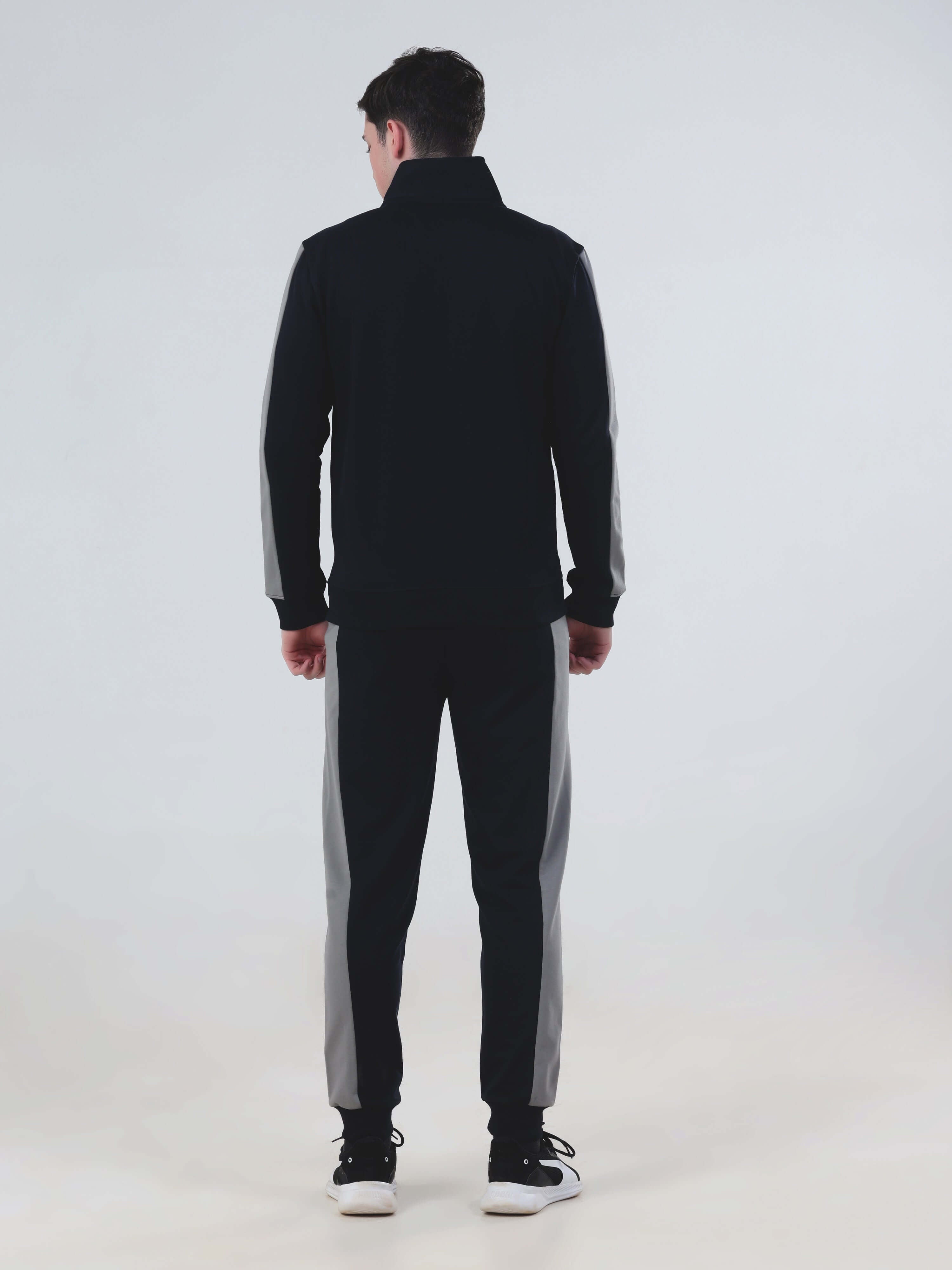 Man wearing a stylish blue Thunder Turms Intelligent co-ord set, showcasing water-resistant jacket and joggers.