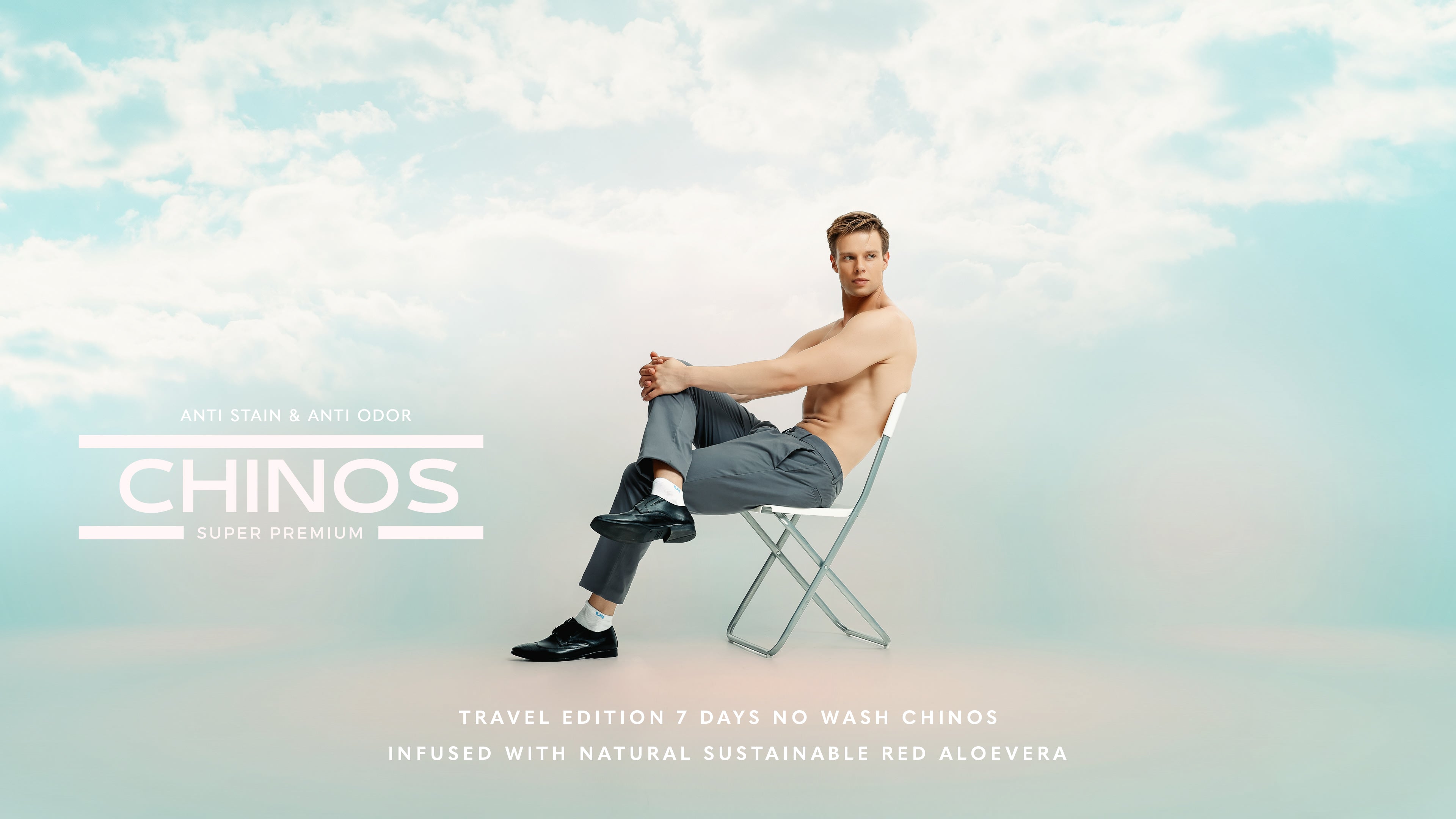 Model showcasing travel edition no wash chinos infused with natural red aloe vera, sitting on a chair against a cloudy background.