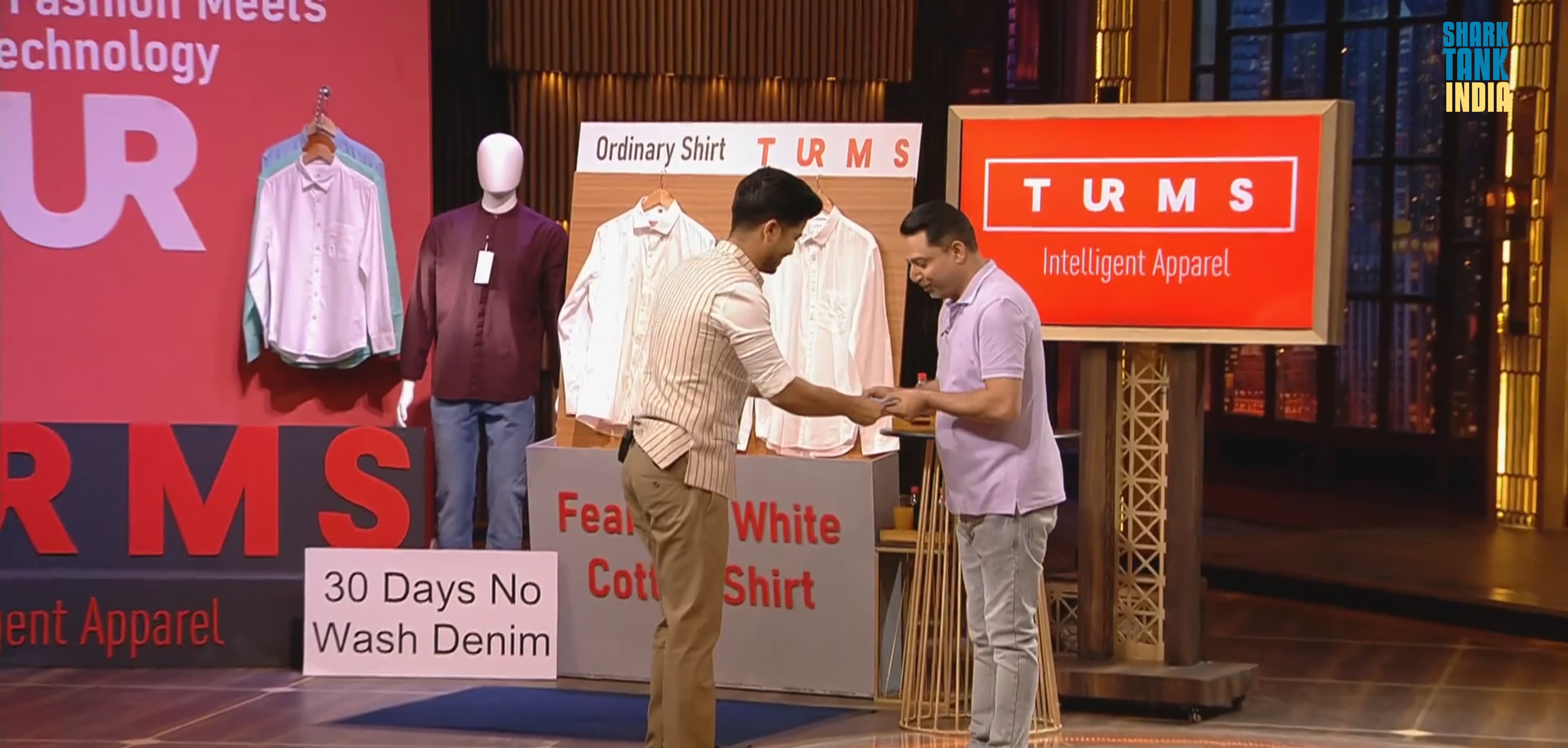 Two men discussing Turms Intelligent Apparel, showcasing innovative menswear technology and features like no-wash denim.