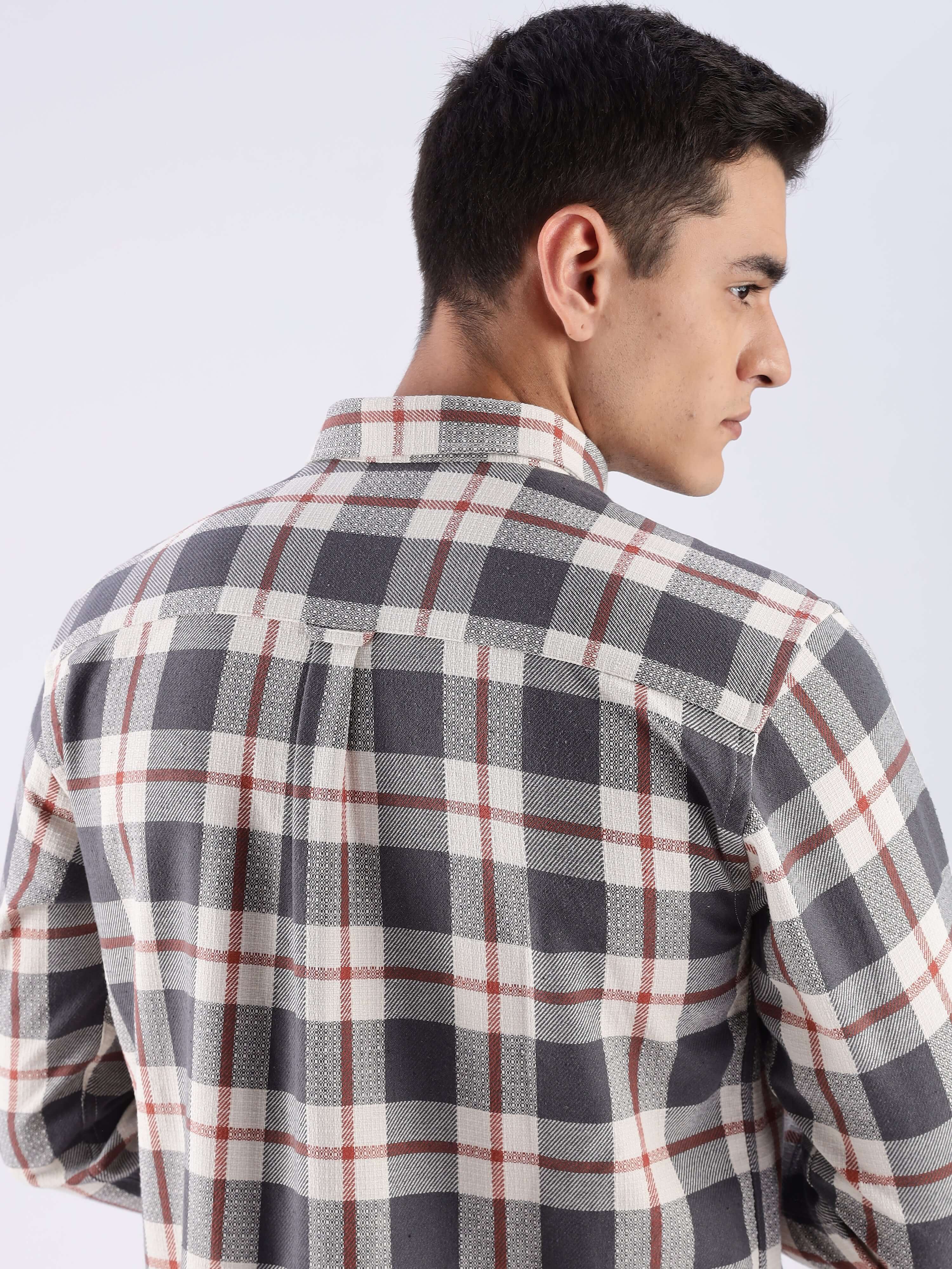 Rear view of a man wearing a grey checked shirt made from sustainable recycled cotton, showcasing its quality and design.