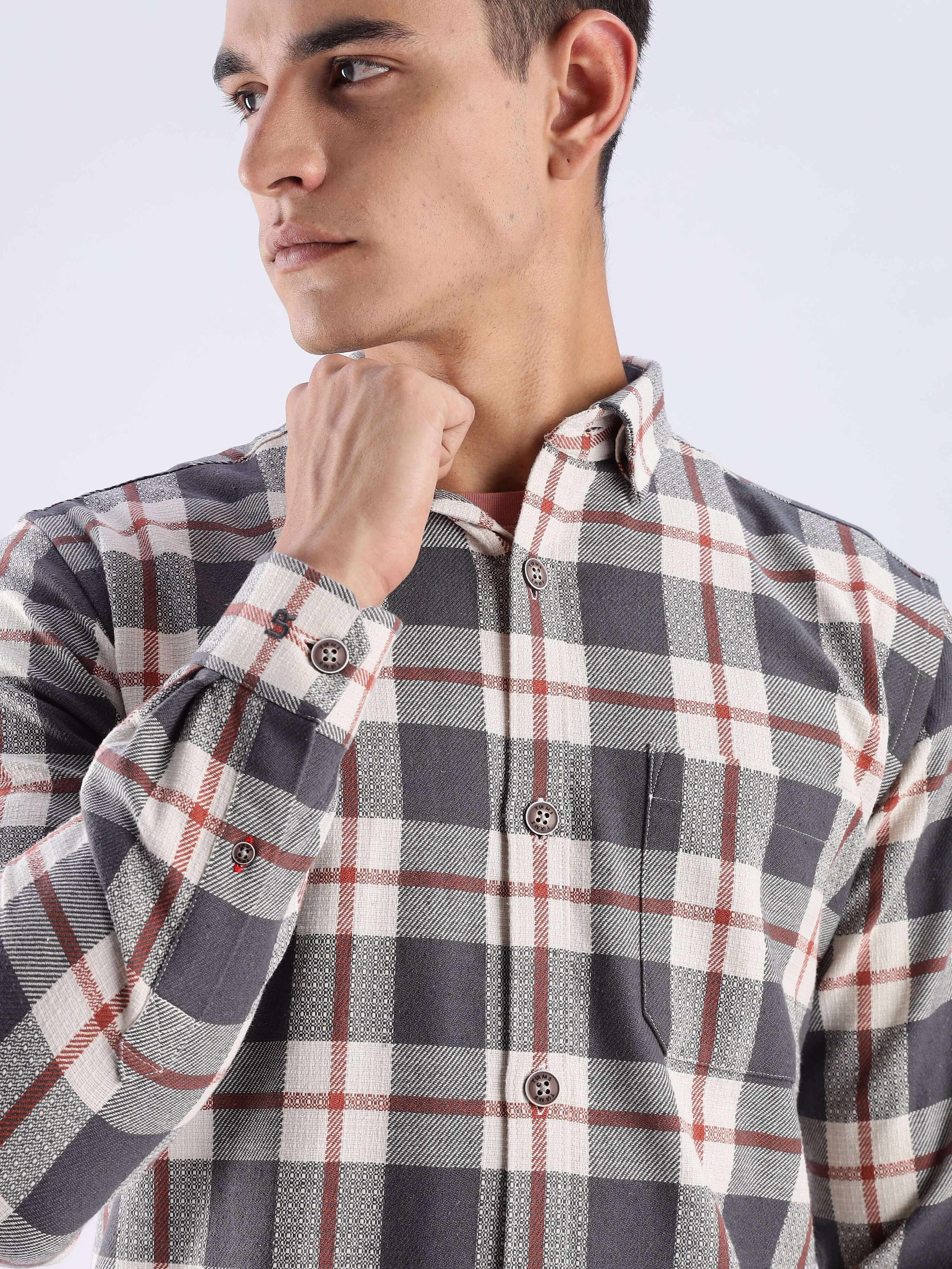 Man wearing a grey checked shirt made from recycled cotton, featuring stylish design and long-lasting quality.