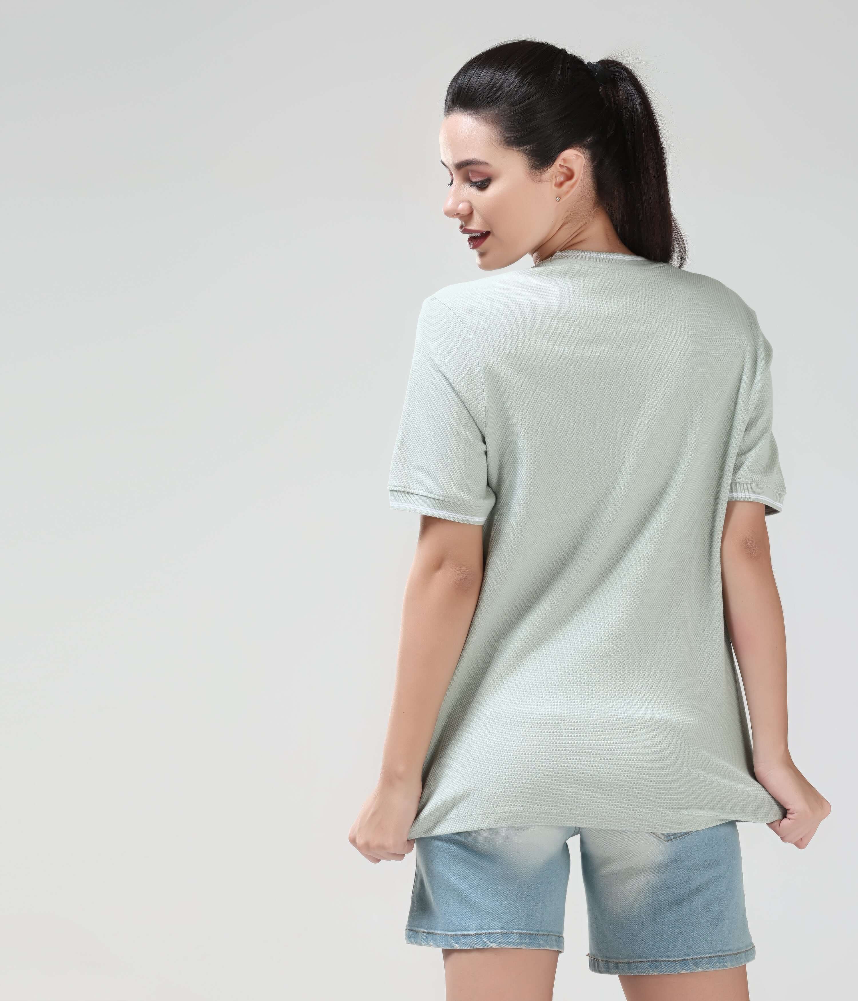 Woman wearing Serene Light Green COOLTECH T-shirt made from honey comb fabric, showcasing anti-odour and anti-microbial intelligent apparel by Turms.