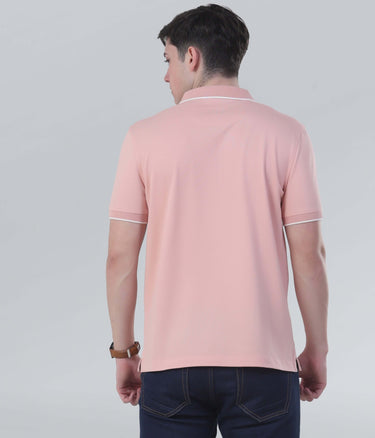 Back view of a man wearing a soft pink polo shirt with sporty design and sleek collar, showcasing stylish comfort.