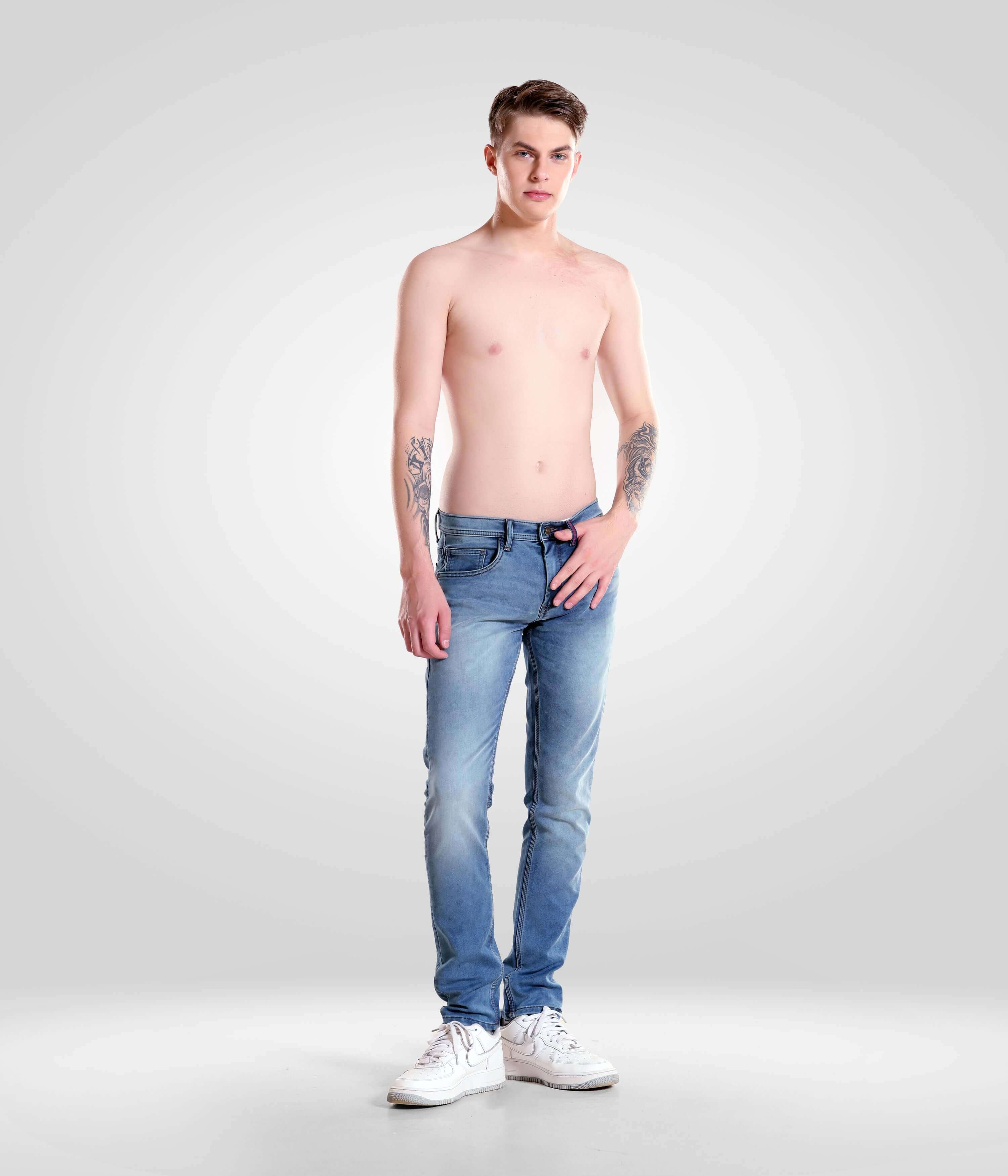 Shirtless man modeling Blue Birdy high-performance denim pants by Turms Intelligent Apparel, a leading menswear brand.