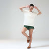 Woman wearing Pearl Off-White COOLTECH T-Shirt with green shorts, featuring honeycomb fabric. NEW COLOUR, anti-odour, and intelligent apparel by Turms.
