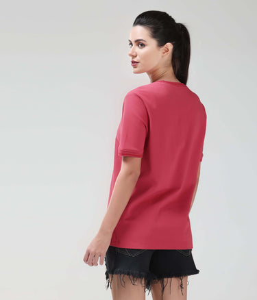 Woman wearing Regal Pink COOLTECH T-shirt by Turms with anti-odour honeycomb fabric, showcasing new colour in intelligent apparel.