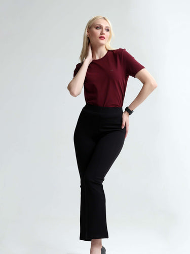 Woman wearing cranberry round-neck Turms T-shirt with tailored fit, paired with black pants.