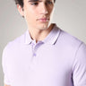 Man wearing light purple Turms Polo T-shirt with tailored fit, featuring anti-stain, anti-odor properties, made from premium cotton and spandex.