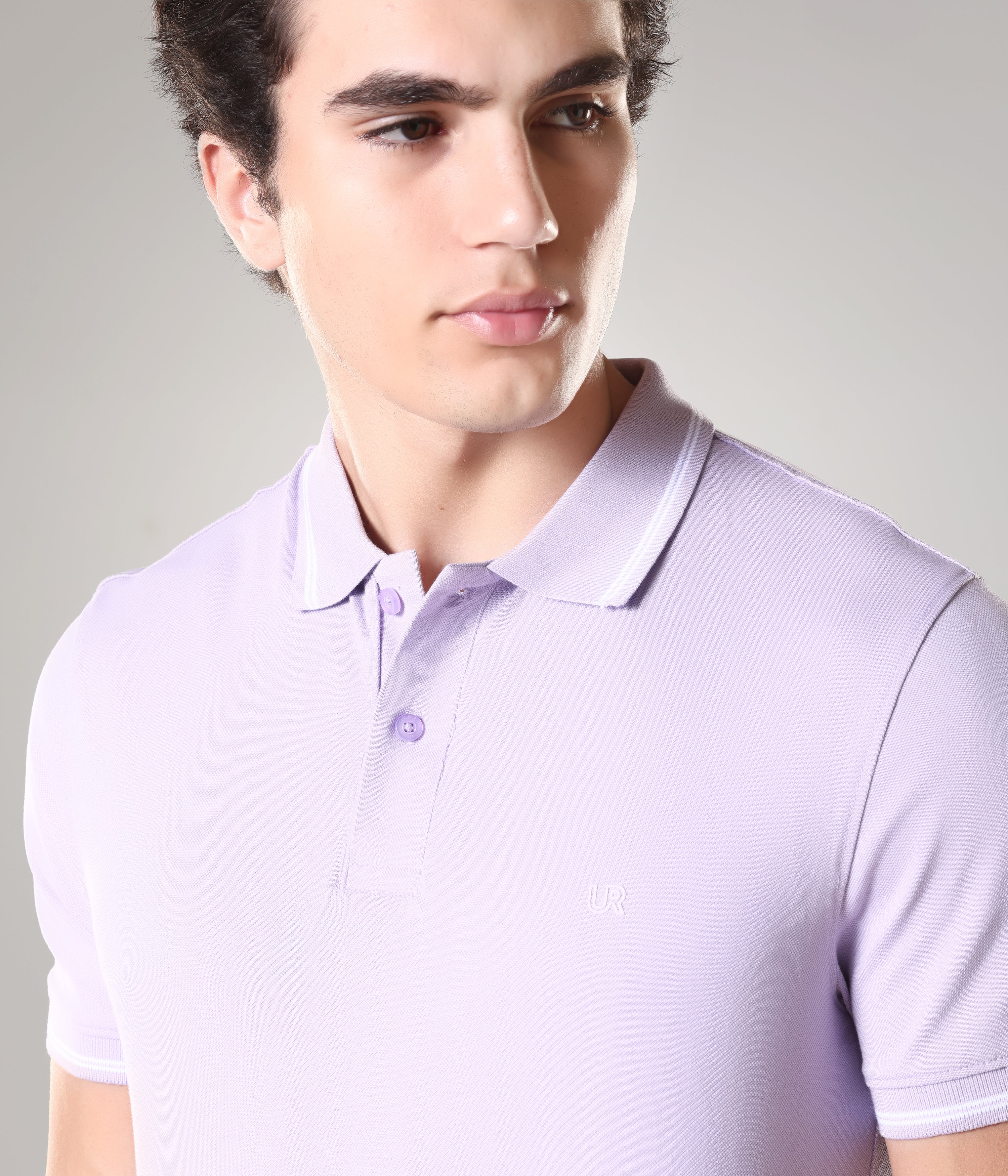 Man wearing light purple Turms Polo T-shirt with tailored fit, featuring anti-stain, anti-odor properties, made from premium cotton and spandex.