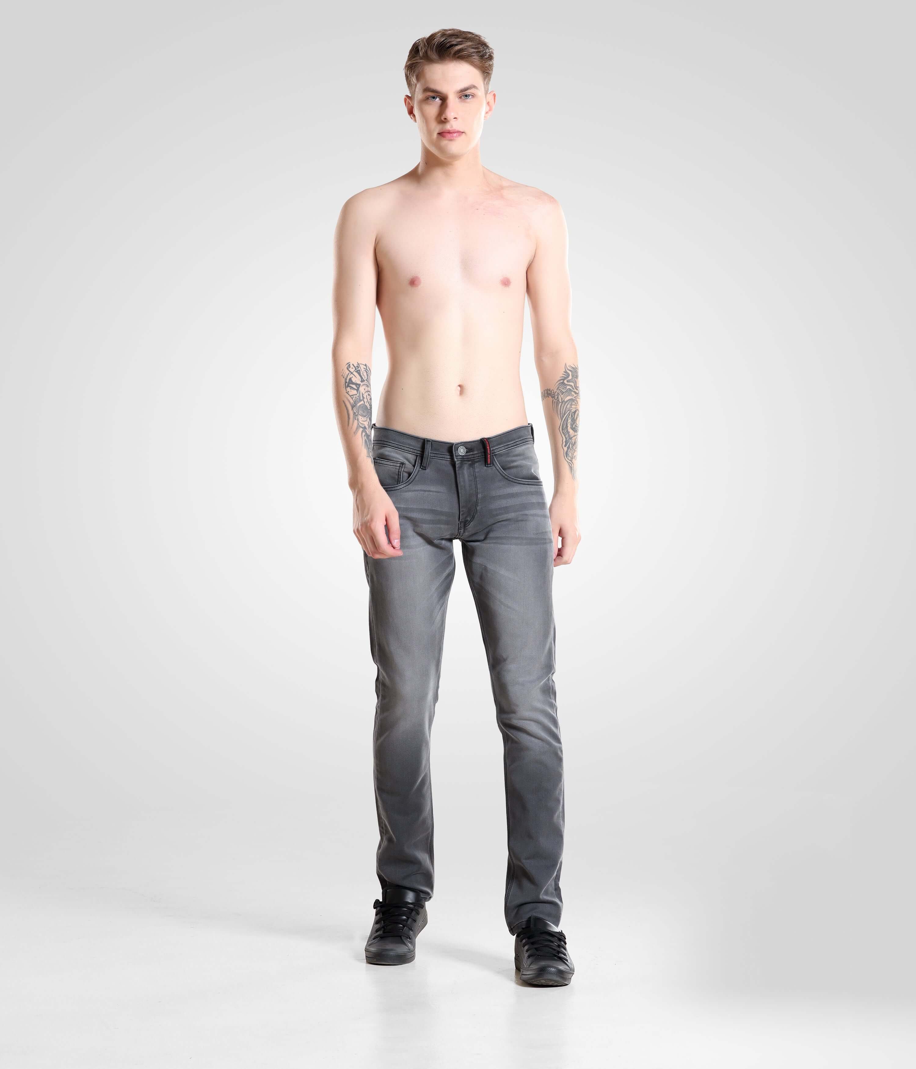 Shirtless male model wearing Grey Monk high-performance denim pants, showcasing Turms Intelligent Apparel menswear best brand.