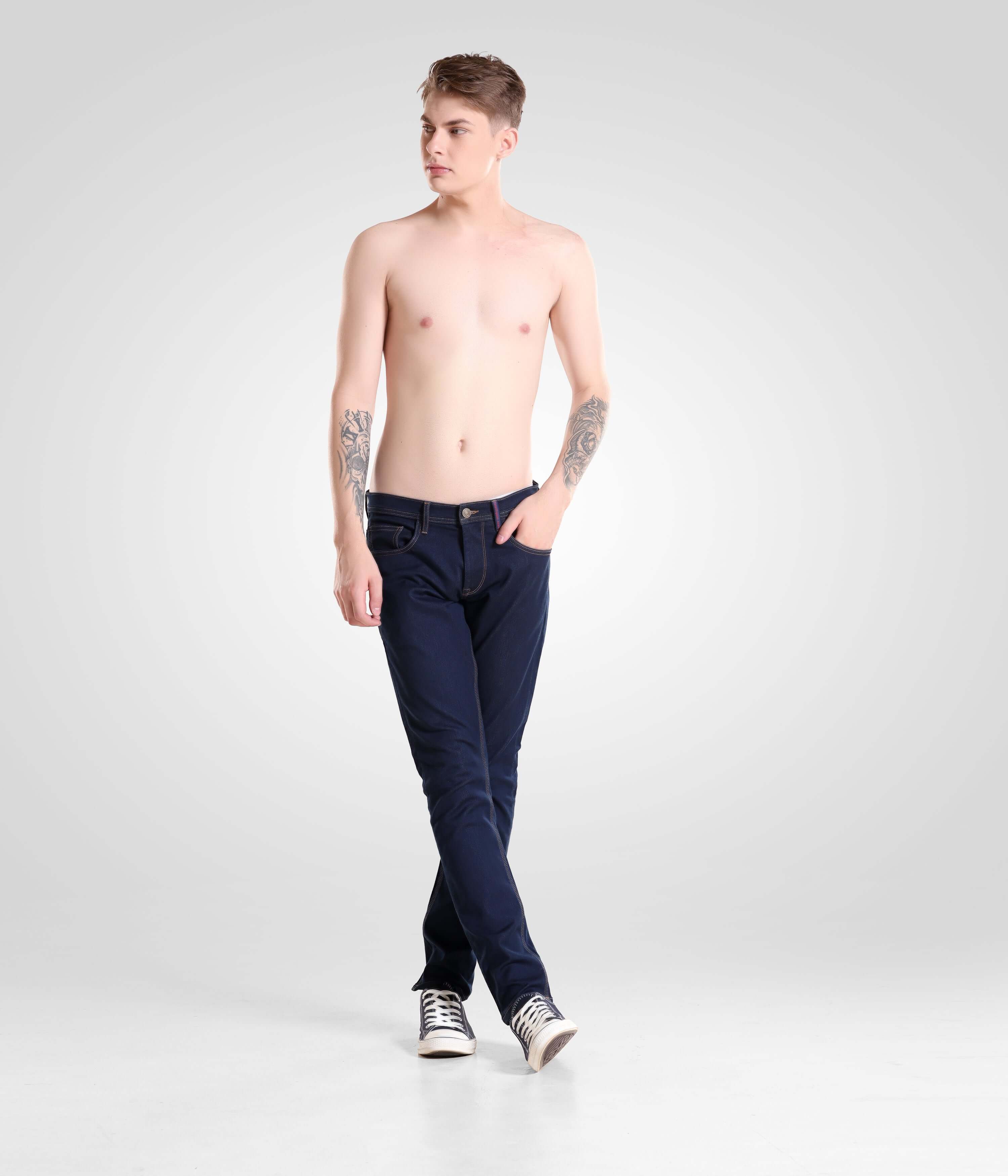 Shirtless man wearing Indigo Trotter high-performance denim pants by Turms Intelligent Apparel, showcasing premium menswear fashion.