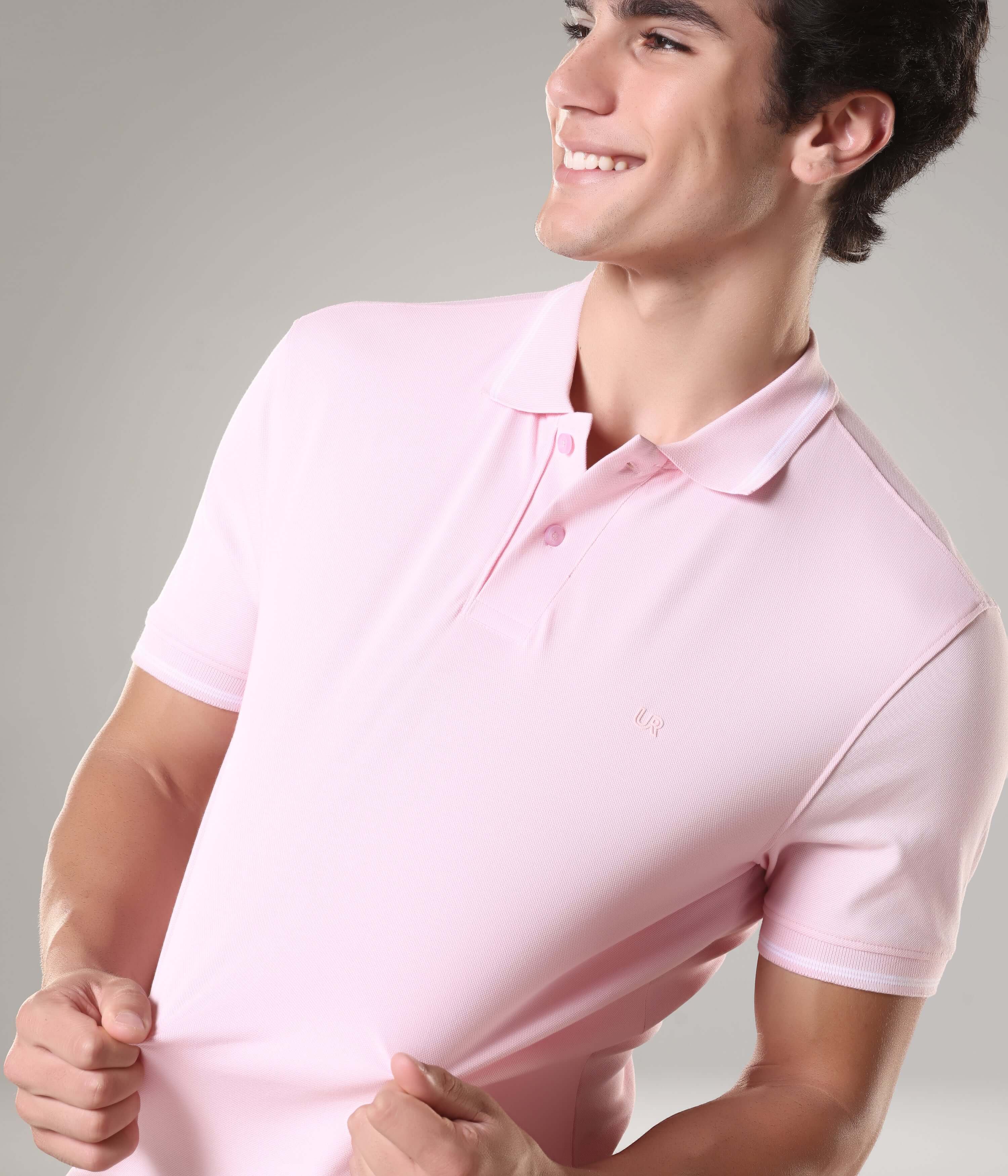 Man wearing light pink Turms intelligent apparel anti-stain, anti-odour premium cotton polo t-shirt with tailored fit.