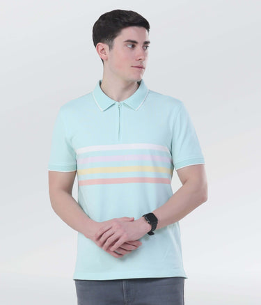 Model wearing a light blue zippered polo shirt with pastel stripes, showcasing stylish and sustainable fashion.