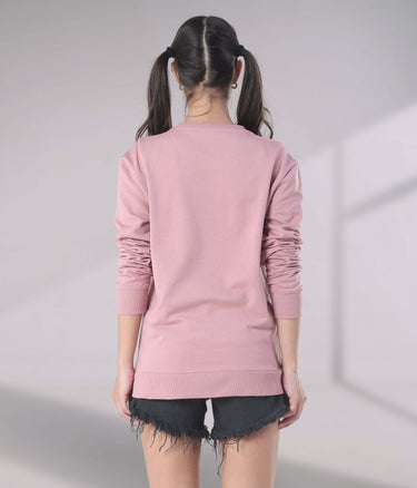 Back view of a woman in a pink Turms Intelligent Sweatshirt, perfect for travel wear with anti-stain and water-resistant features.