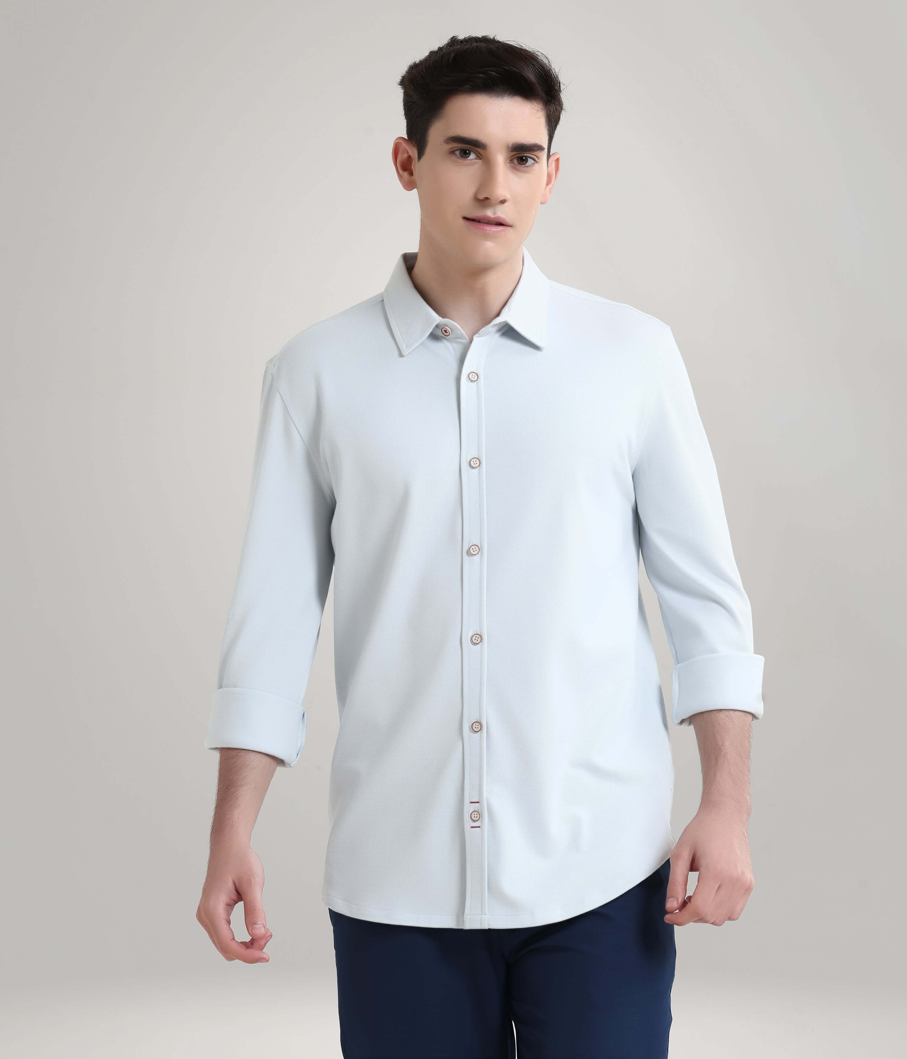 Man wearing Ethereal Blue Knitted Turms Stretchable Shirt, premium menswear with anti-stain and anti-odour features.