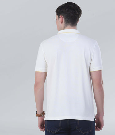 Back view of a man wearing a vanilla cream polo shirt showcasing its soft fabric and classic design.