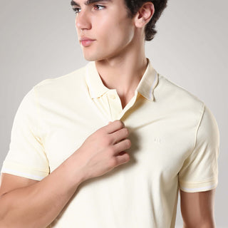Man wearing a yellow Turms Polo T-Shirt made from 95% premium cotton and 5% Lycra, featuring anti-stain, anti-odour, and anti-microbial technology.