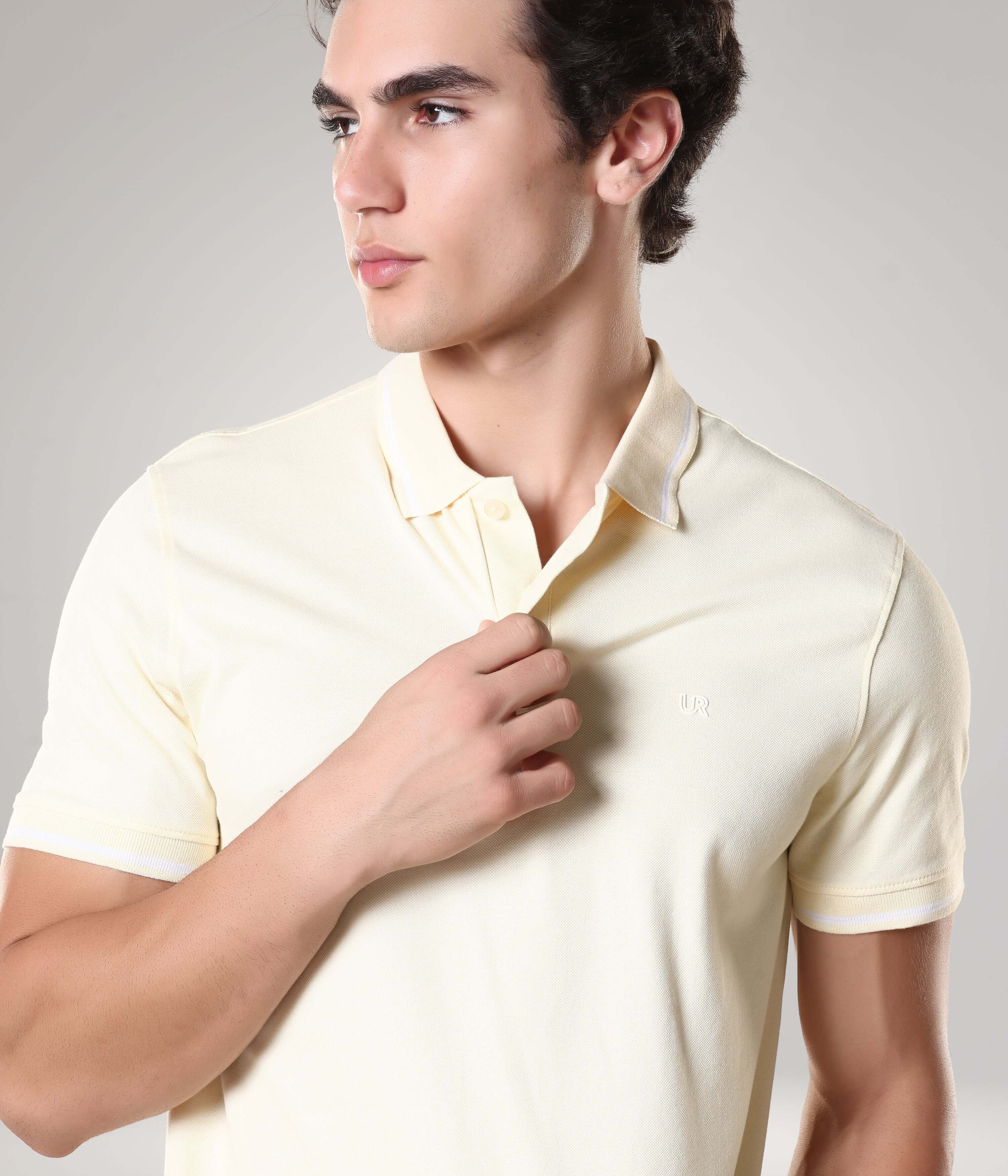 Man wearing a yellow Turms Polo T-Shirt made from 95% premium cotton and 5% Lycra, featuring anti-stain, anti-odour, and anti-microbial technology.