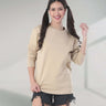 Stylish woman in beige Turms Intelligent Sweatshirt, showcasing comfort and sporty design for casual wear.