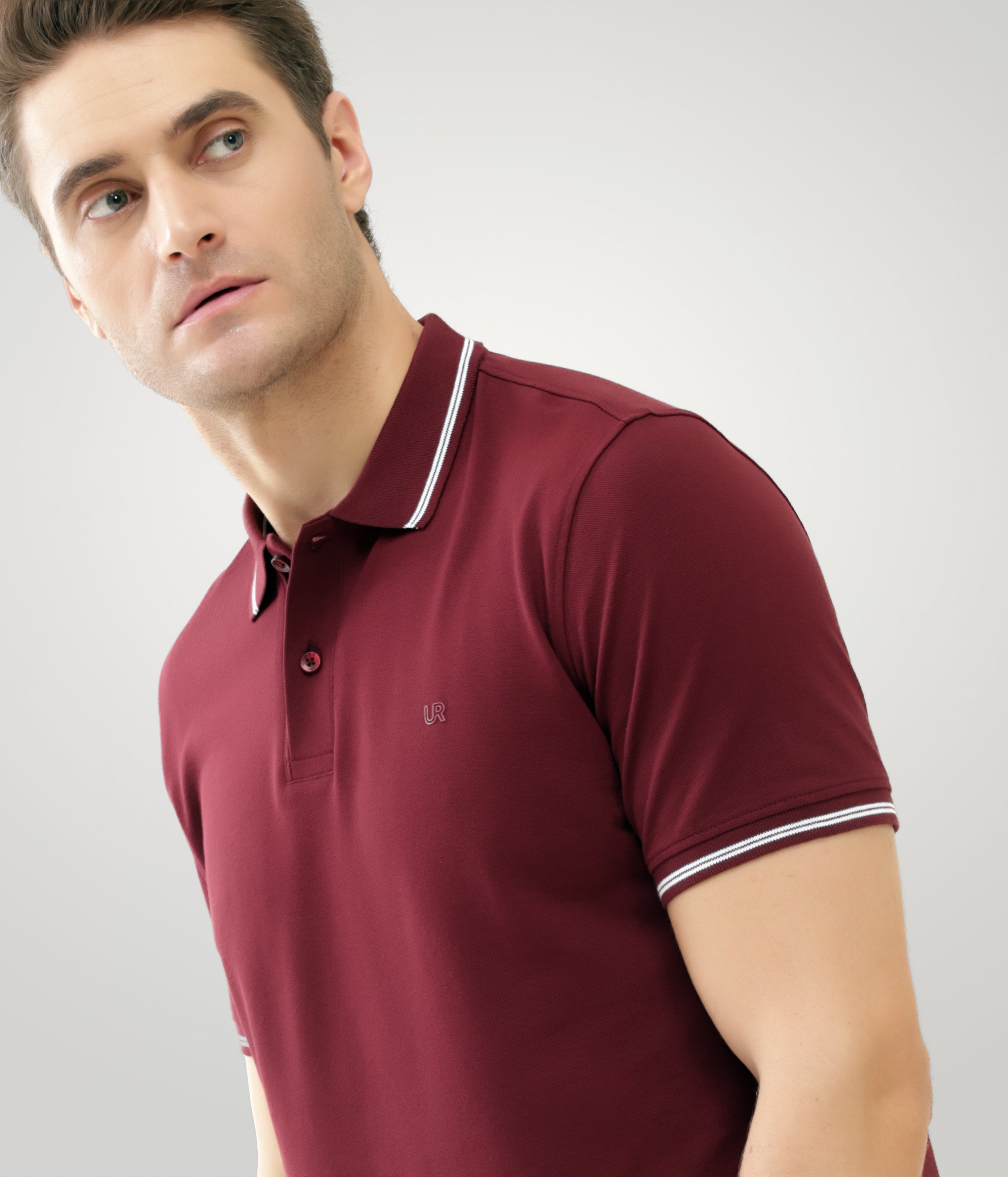 Man wearing maroon Turms anti-stain, anti-odor premium cotton polo T-shirt with tailored fit and white striped collar