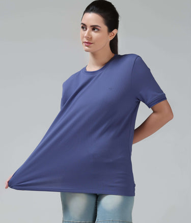Woman wearing Blooming Orchid CoolTech T-Shirt by Turms with round neck, tailored fit, anti-odour, honeycomb fabric, and intelligent apparel technology.