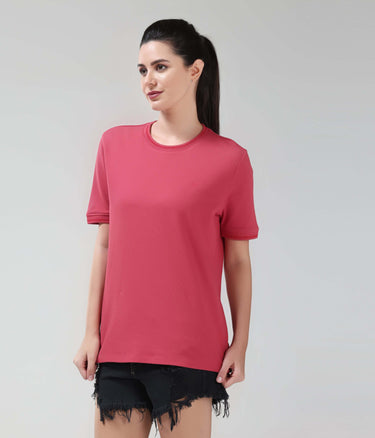 Woman wearing Regal Pink CoolTech T-shirt by Turms, tailored fit, made with anti-odour honeycomb fabric, showcasing new colour in intelligent apparel.