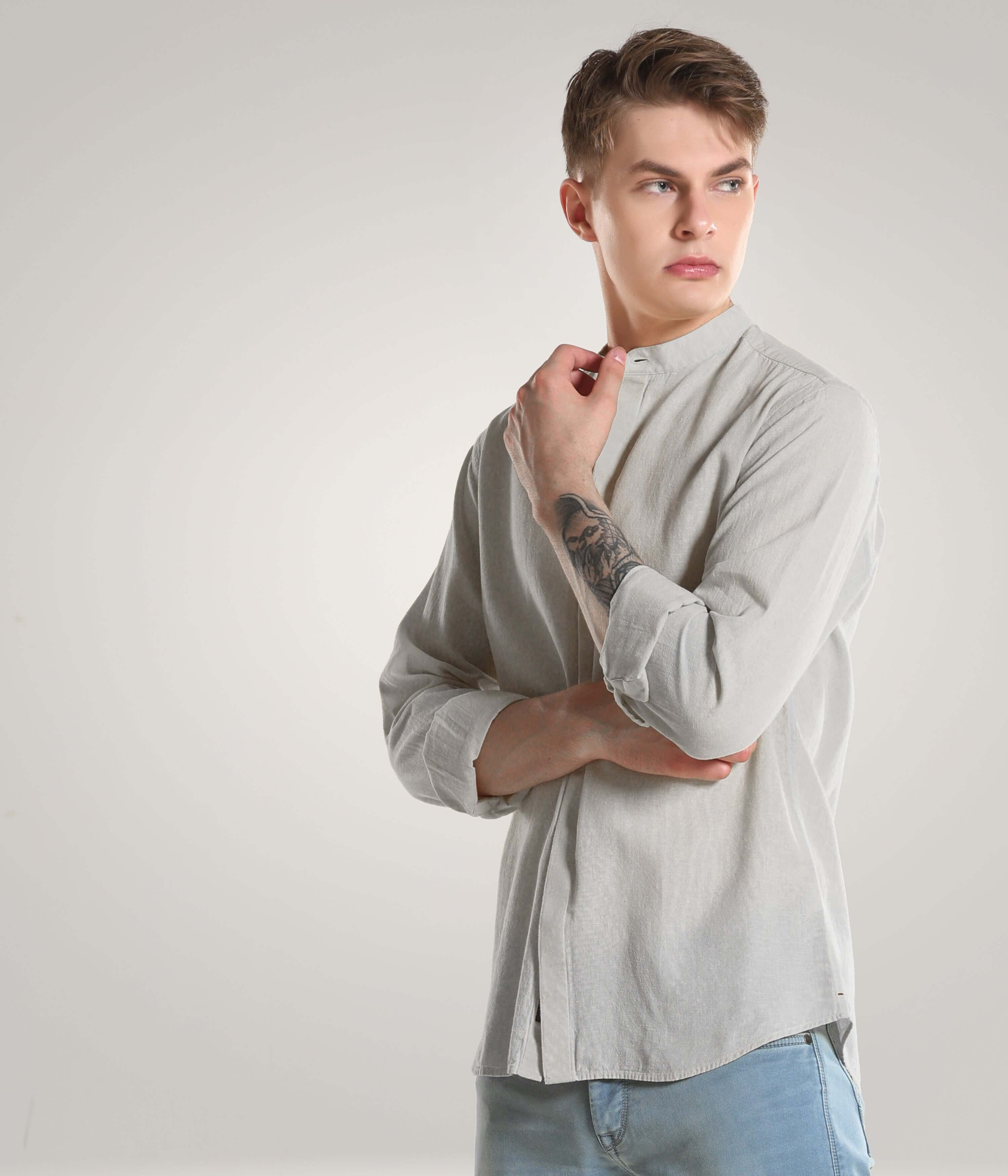 Man wearing a Storm Grey Turms Intelligent Apparel cotton/linen shirt with premium mandarin collars, showcasing premium clothing and meticulous stitching