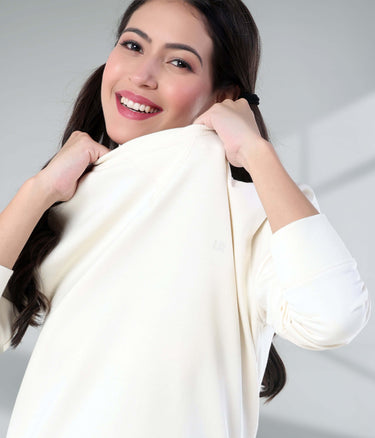 Woman smiling in a soft Artic White Turms Intelligent Sweatshirt, showcasing style and comfort. Perfect for travel wear.