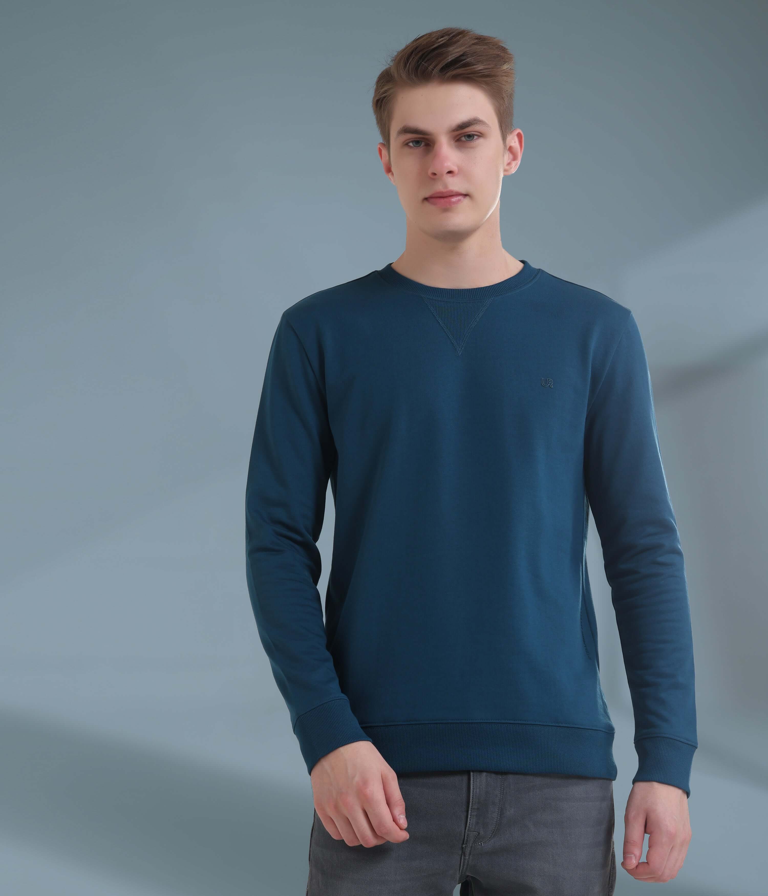 Man wearing a blue sweatshirt, showcasing style and comfort, ideal for everyday wear and outdoor activities.