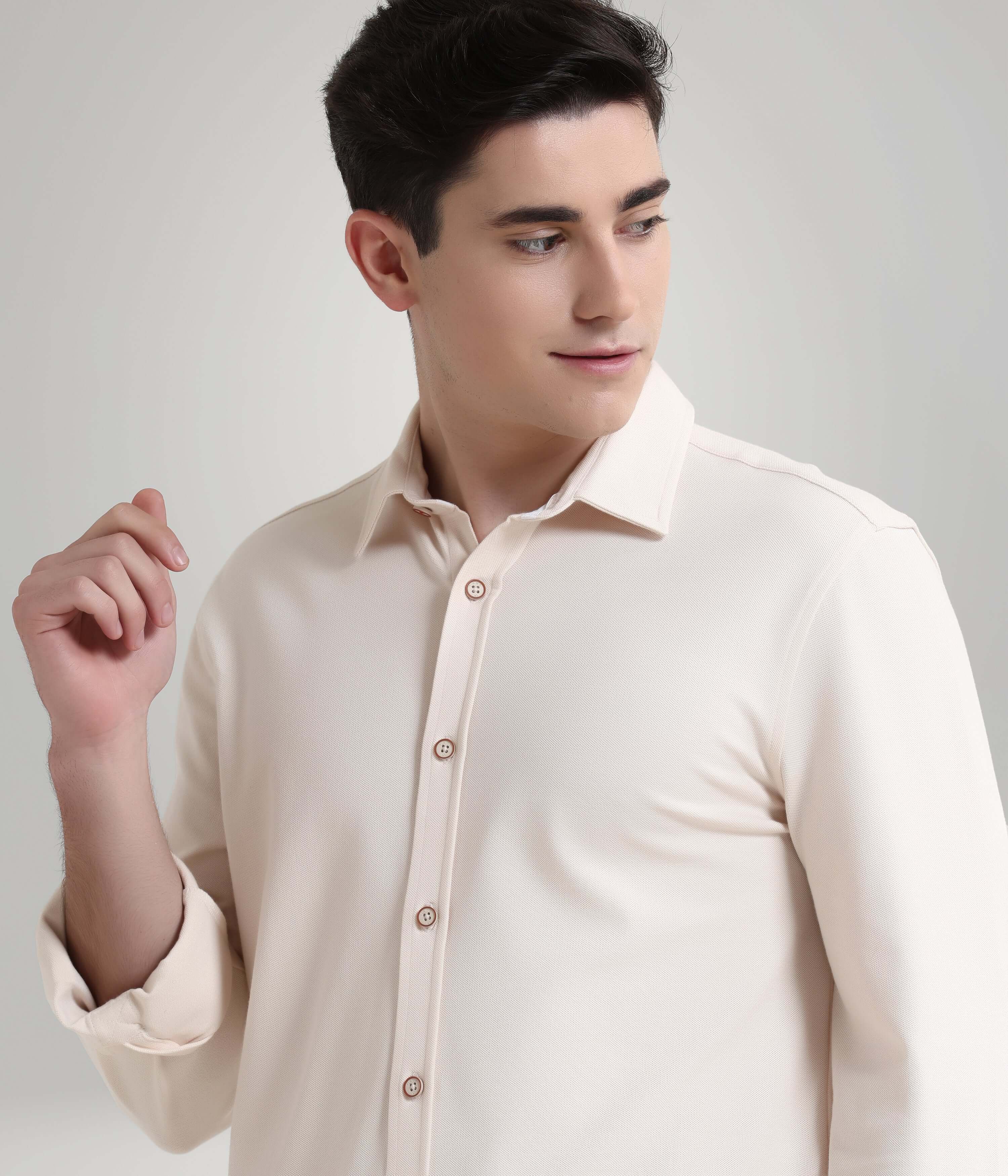 Man wearing Dusky Beige Knitted Turms Stretchable Shirt, showcasing premium menswear with anti-stain and anti-odour features.