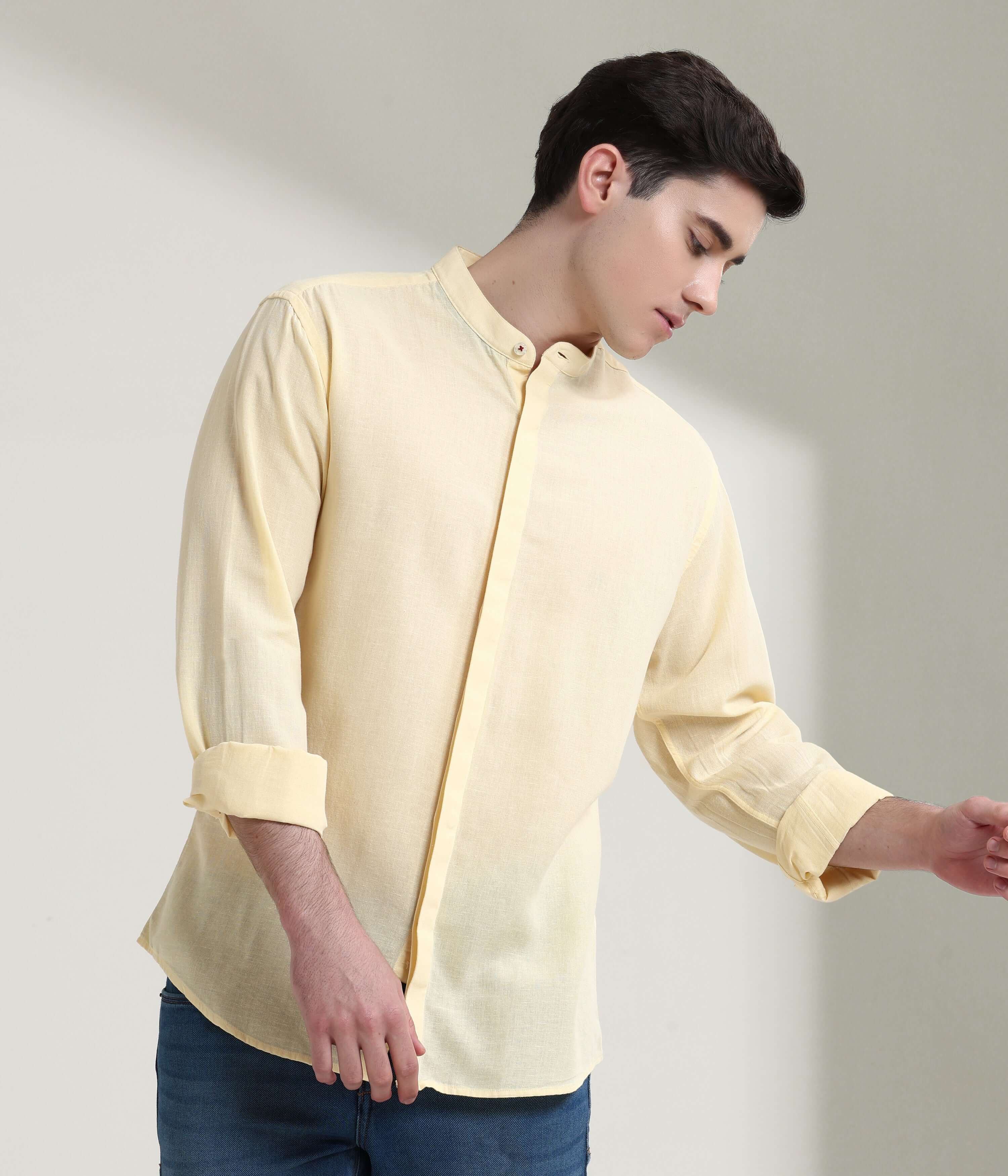 Pastel yellow linen shirt with mandarin collar by Turms, featuring anti-stain and anti-odour intelligent apparel technology.