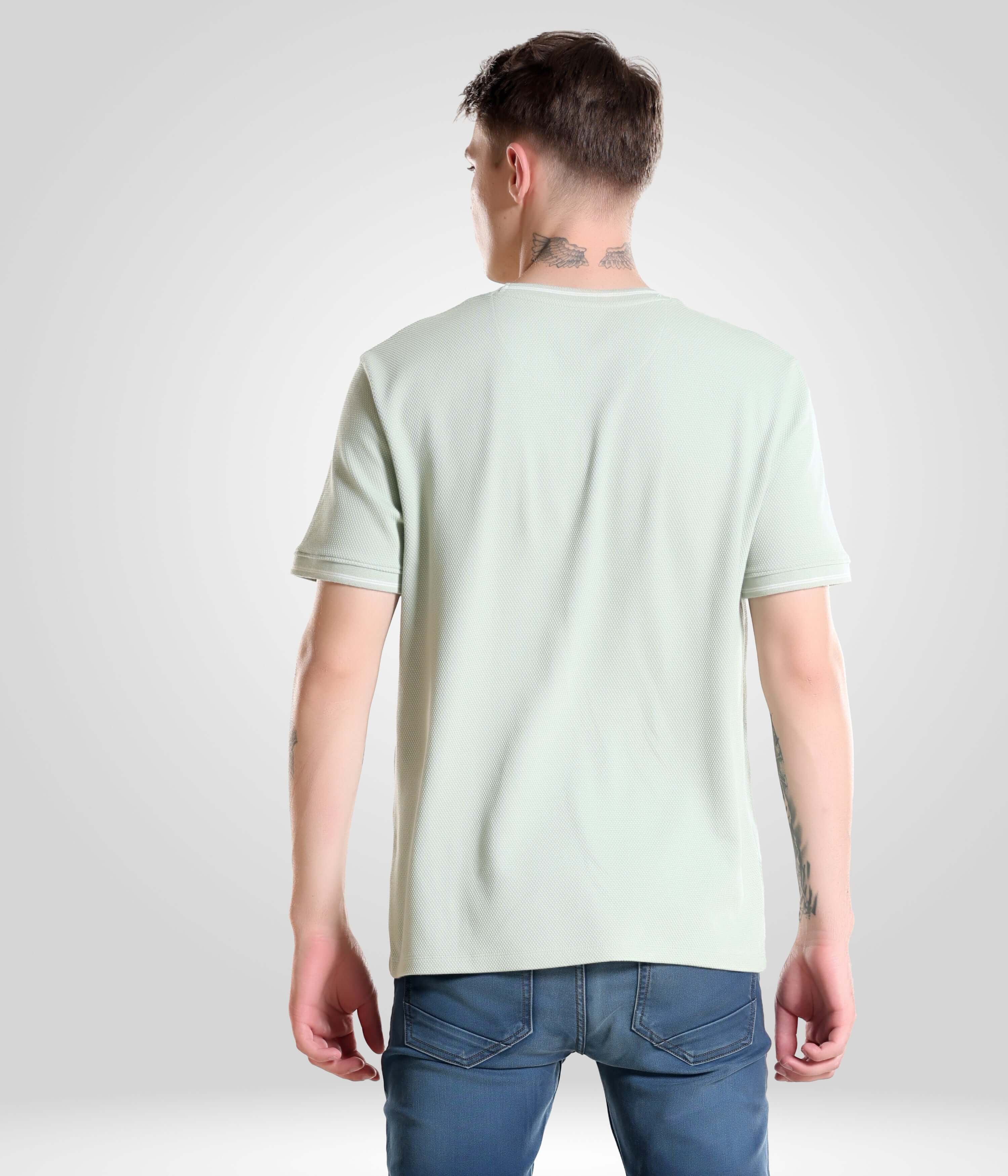 Man wearing a Serene Light Green Turms T-shirt, tailored fit crew neck from menswear best brand, stays cool and comfortable with anti-microbial fabric.