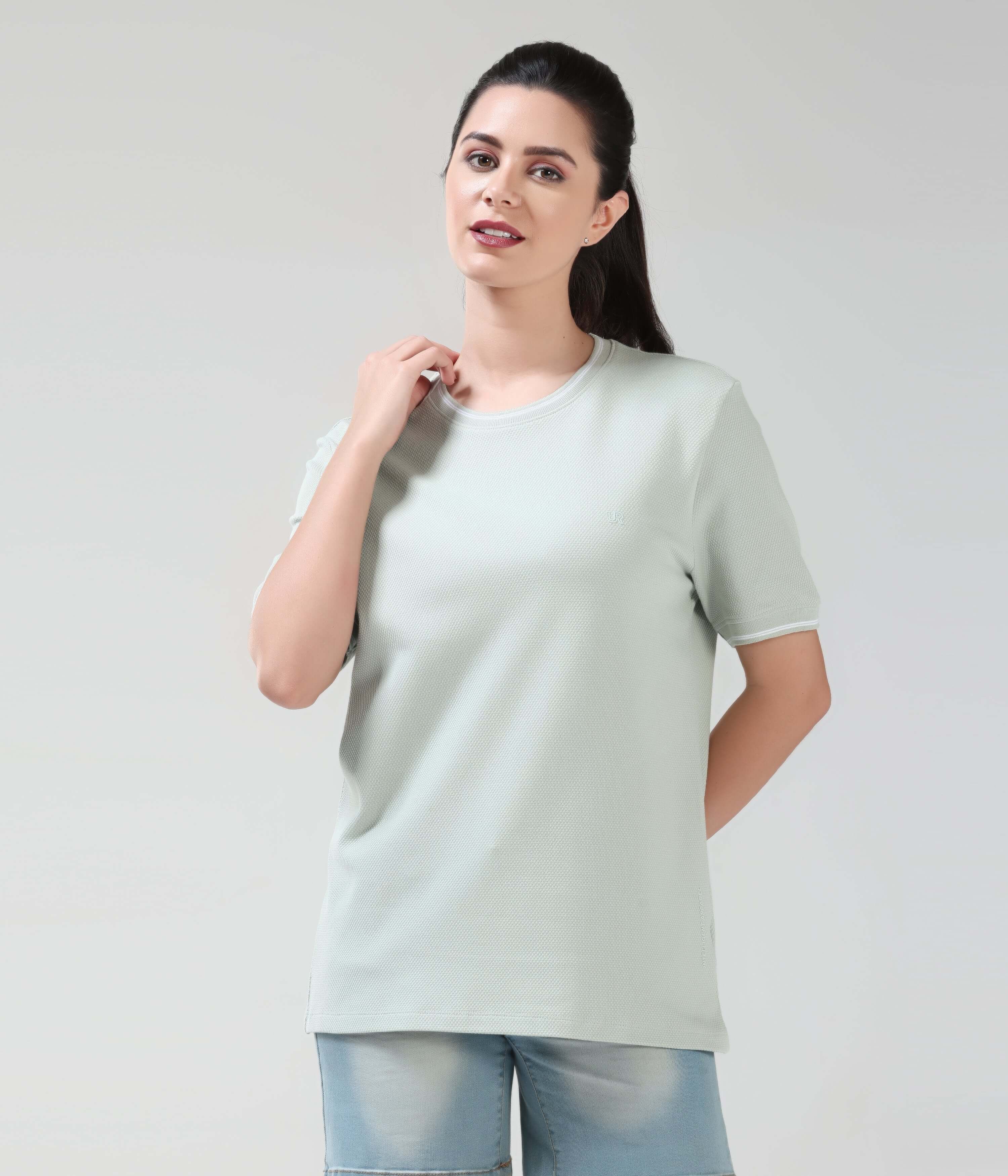 Woman wearing Serene Light Green COOLTECH Tshirt by Turms, featuring Honey Comb Fabric & Anti-Odour, perfect for staying cool.