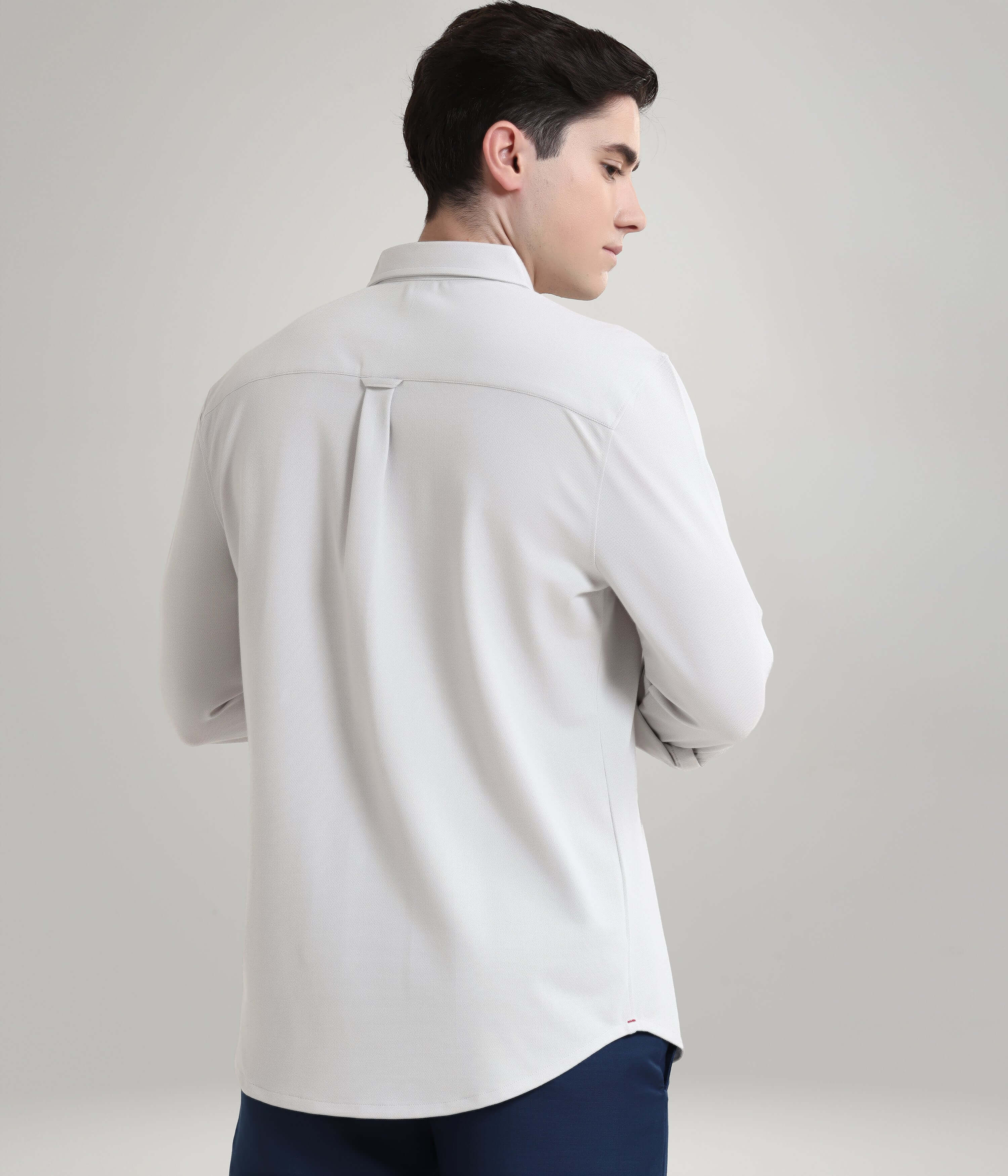 Man wearing Ashen Grey knitted stripe shirt, anti-stain, anti-odour premium menswear, showcasing back view design.