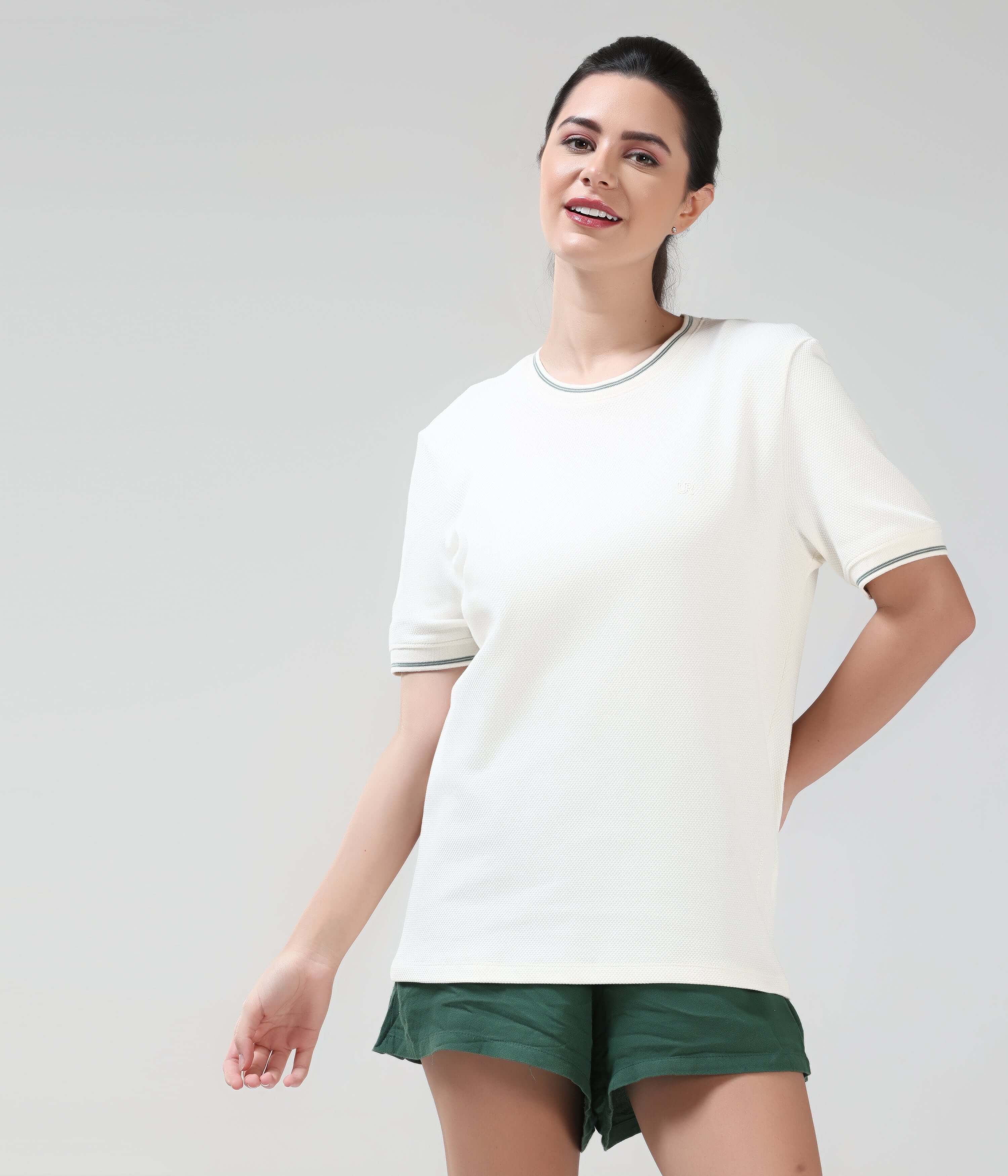 Woman wearing Pearl Off White COOLTECH T-shirt by Turms, featuring a tailored fit and honeycomb fabric, provides anti-odour protection and intelligent apparel technology.