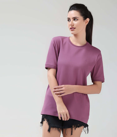 Woman wearing a dusty rose COOLTECH t-shirt by TURMS, featuring anti-odour honeycomb fabric and intelligent apparel design. New colour available.