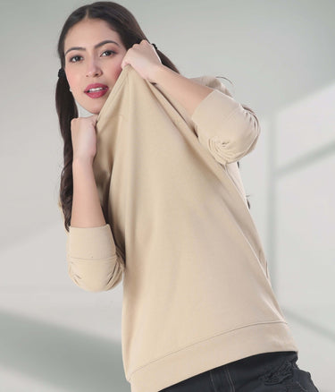 Woman in beige Turms Intelligent Sweatshirt showcasing style, comfort, and innovative features for travel wear.