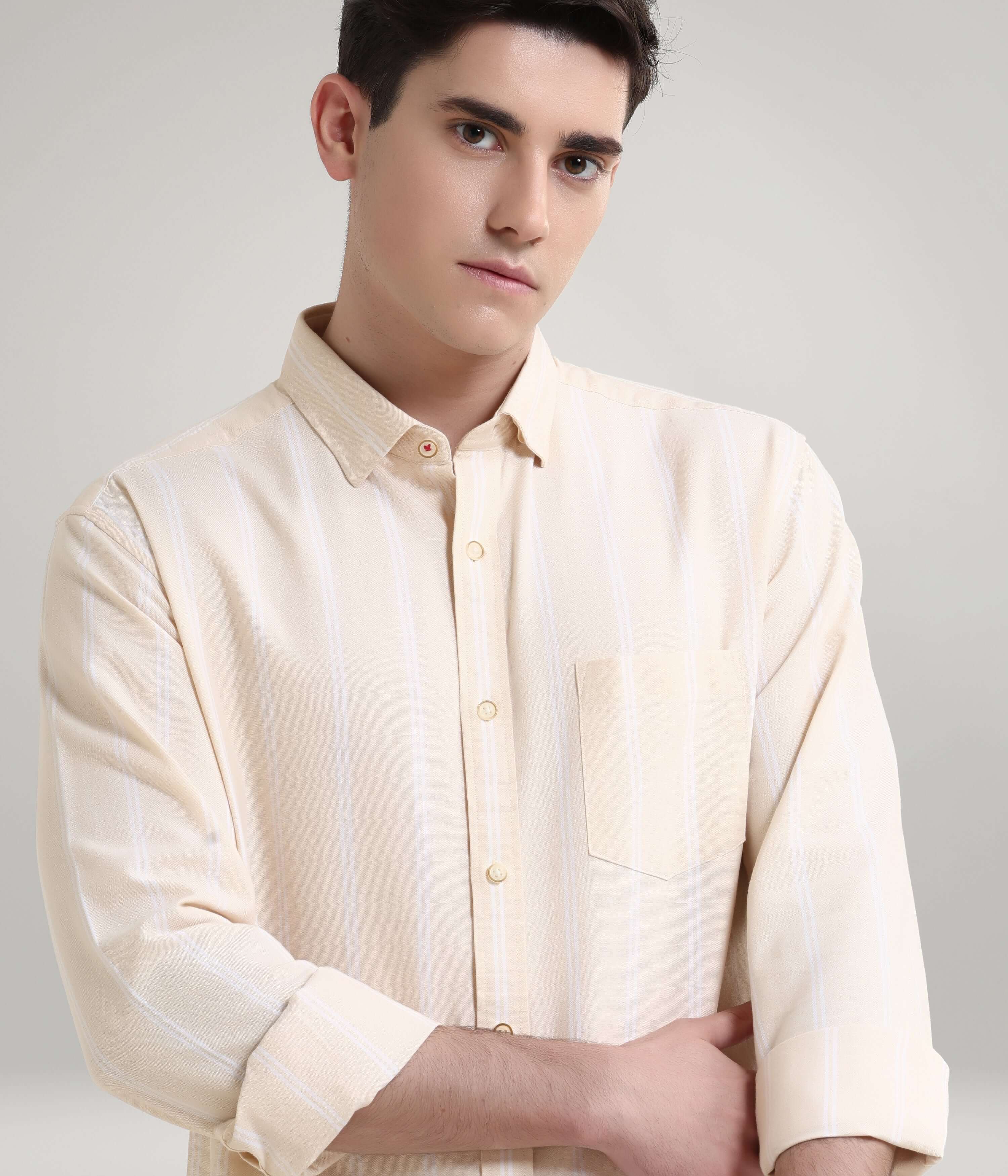 Man wearing Dessert Beige Oxford Turms knitted stripe shirt, anti-stain and anti-odour, showcasing premium menswear fashion.