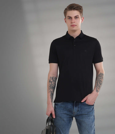 Black tailored-fit polo t-shirt exhibiting anti-stain, anti-odor properties, perfect for modern menswear style.