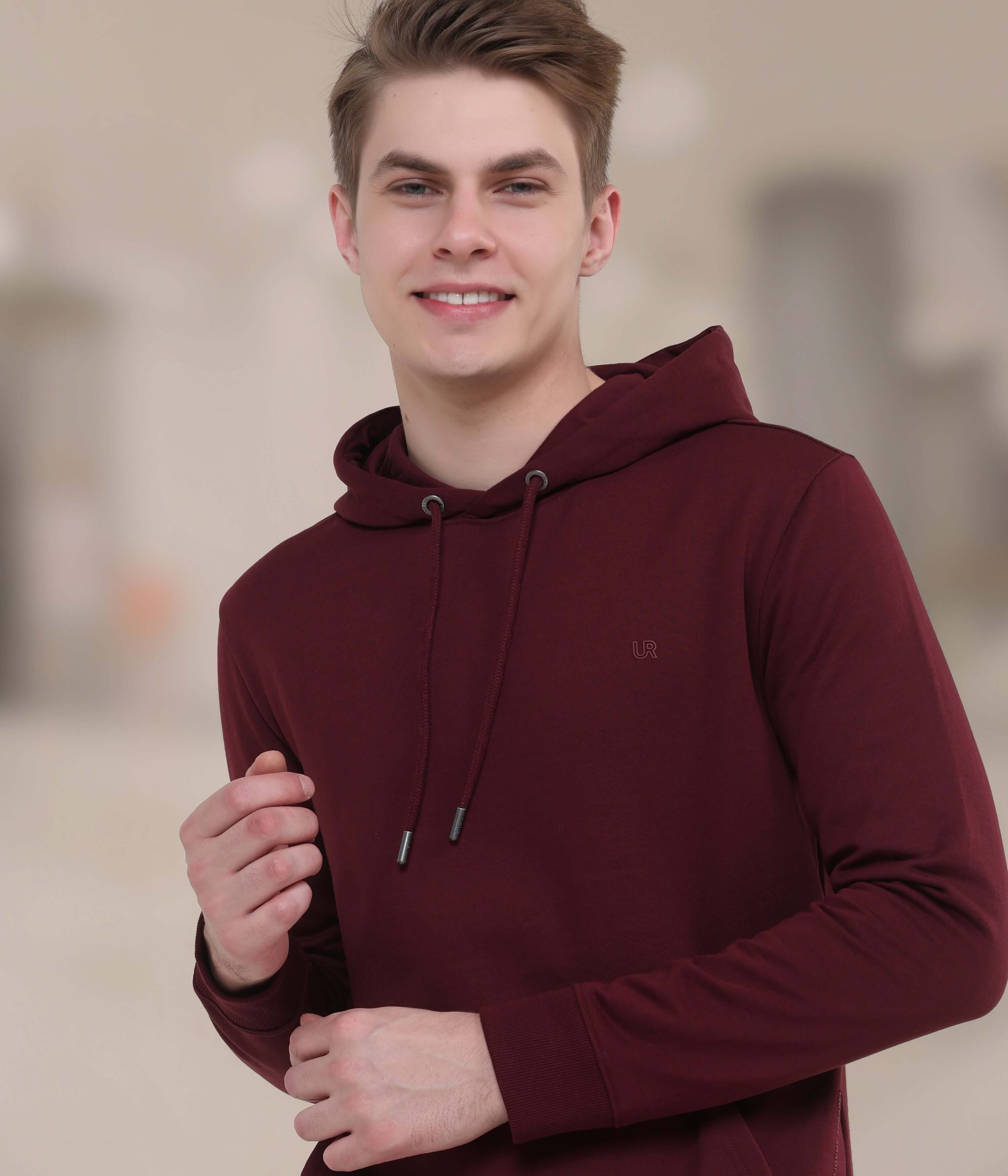 Model wearing a burgundy Turms Intelligent Hooded Sweatshirt, showcasing style and comfort for everyday wear.