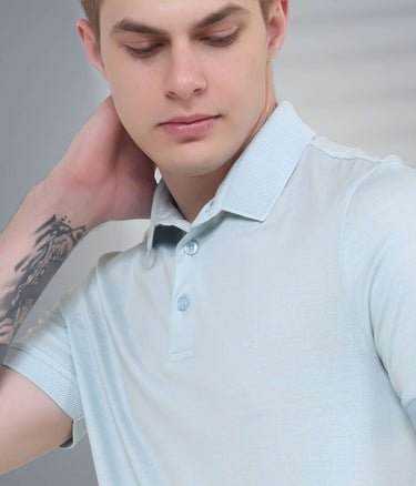 Model showcasing a light blue stain-proof polo t-shirt with tailored fit and anti-odor features, perfect for casual wear.