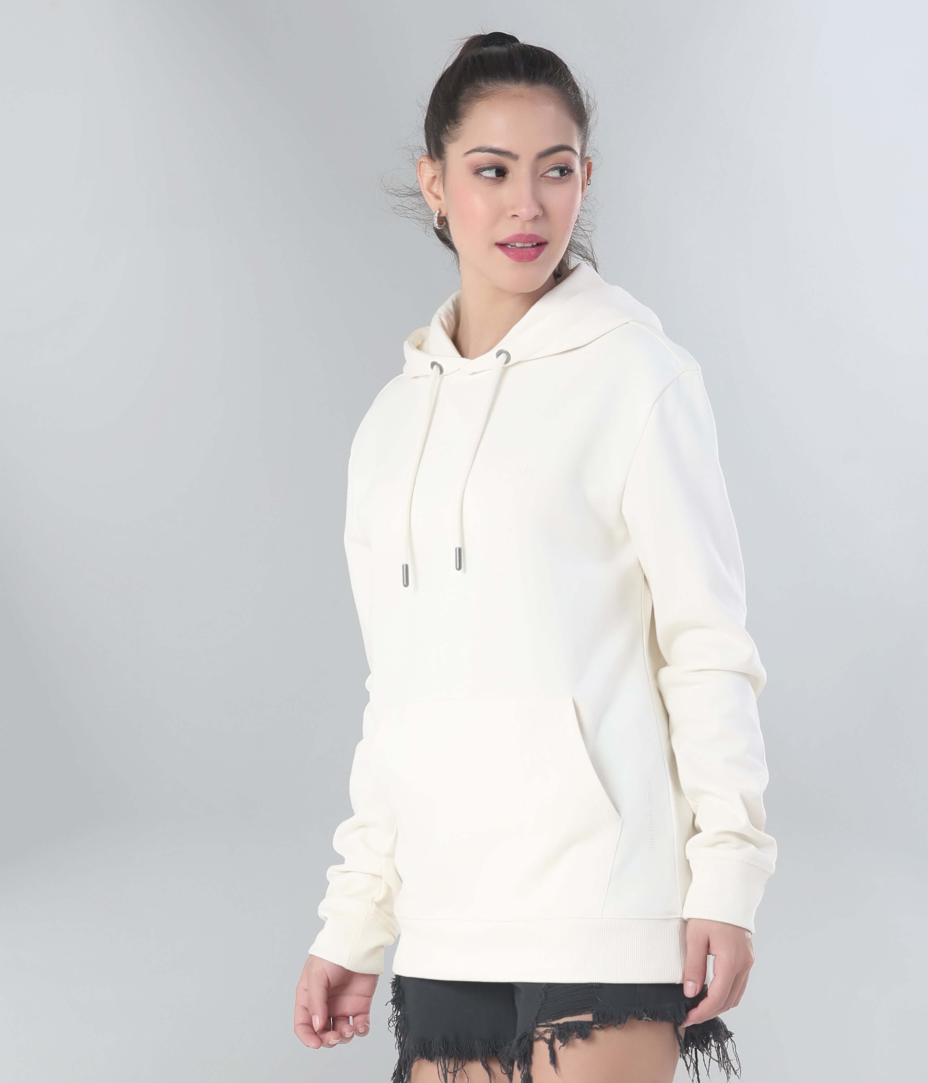 Woman in cream Turms Intelligent Hooded Sweatshirt, best for travel wear, featuring anti-stain and water-resistant properties.