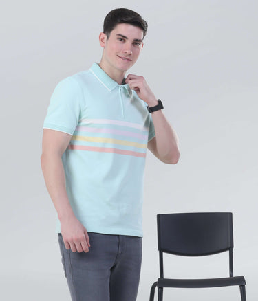 Model wearing a light blue polo shirt with pastel stripes, showcasing a stylish and comfortable design.
