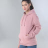 Stylish woman wearing a pink hooded sweatshirt, showcasing comfort and versatility for everyday wear.