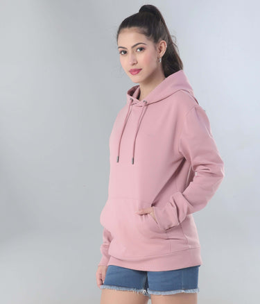 Stylish woman wearing a pink hooded sweatshirt, showcasing comfort and versatility for everyday wear.