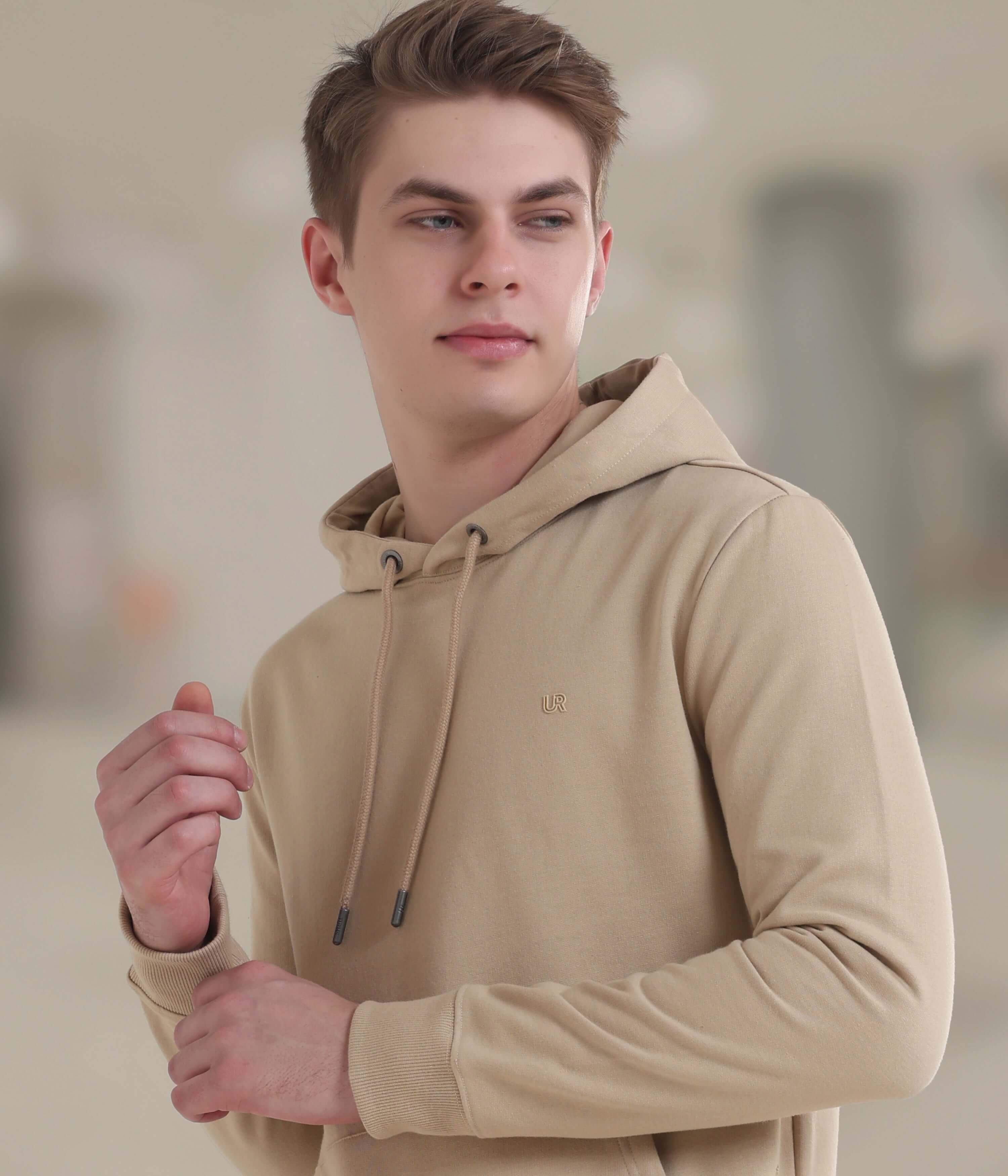 Model wearing a camel-colored Turms Intelligent Hooded Sweatshirt, showcasing style and comfort for everyday wear.