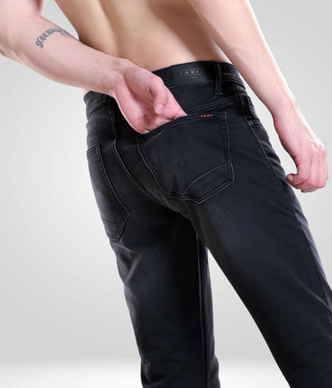 Man wearing Black Sparrow high-performance denim pants featuring Turms intelligent apparel, ideal menswear from a top brand.